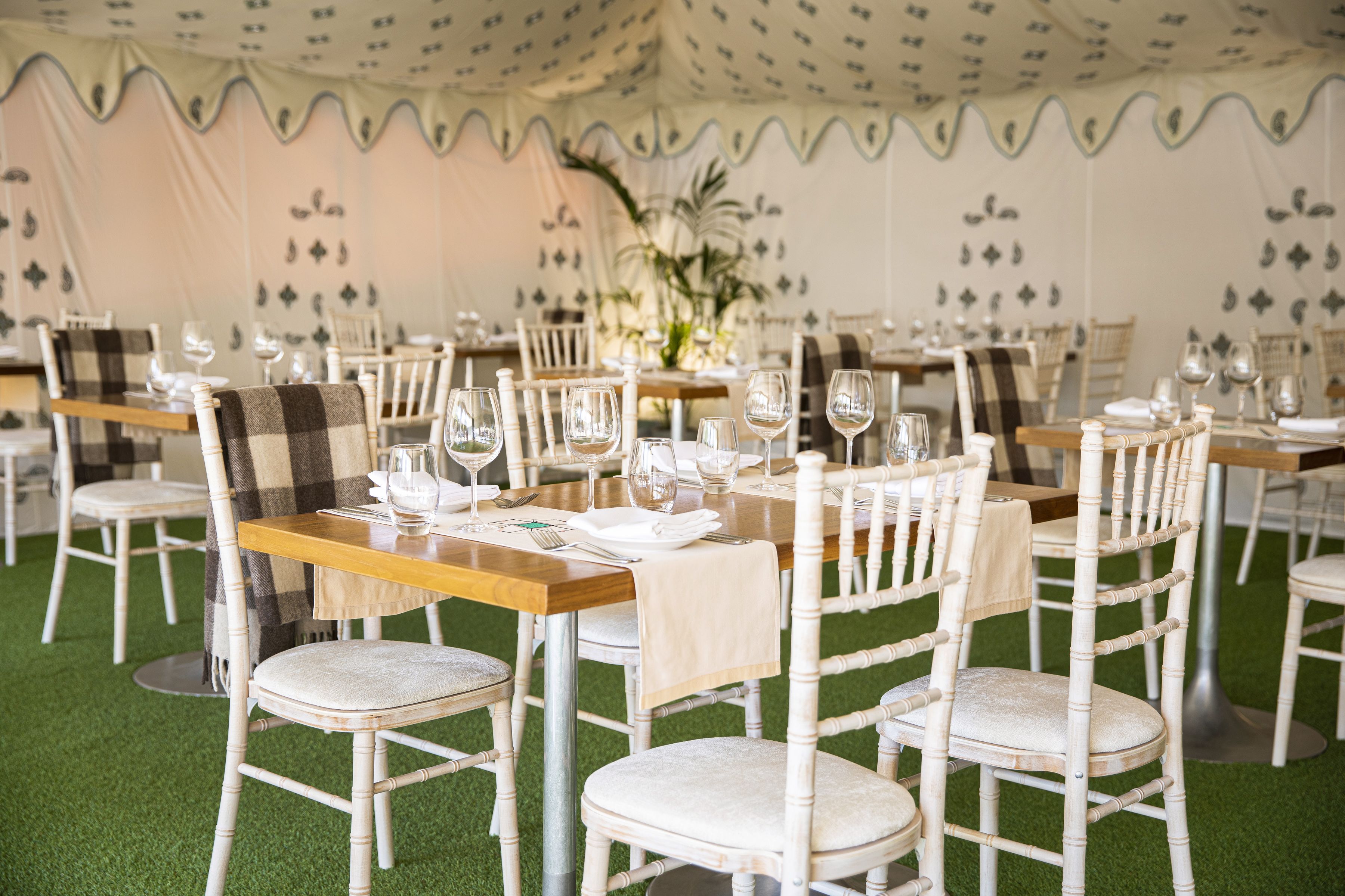 Elegant marquee event space with stylish tables, ideal for upscale gatherings and celebrations.