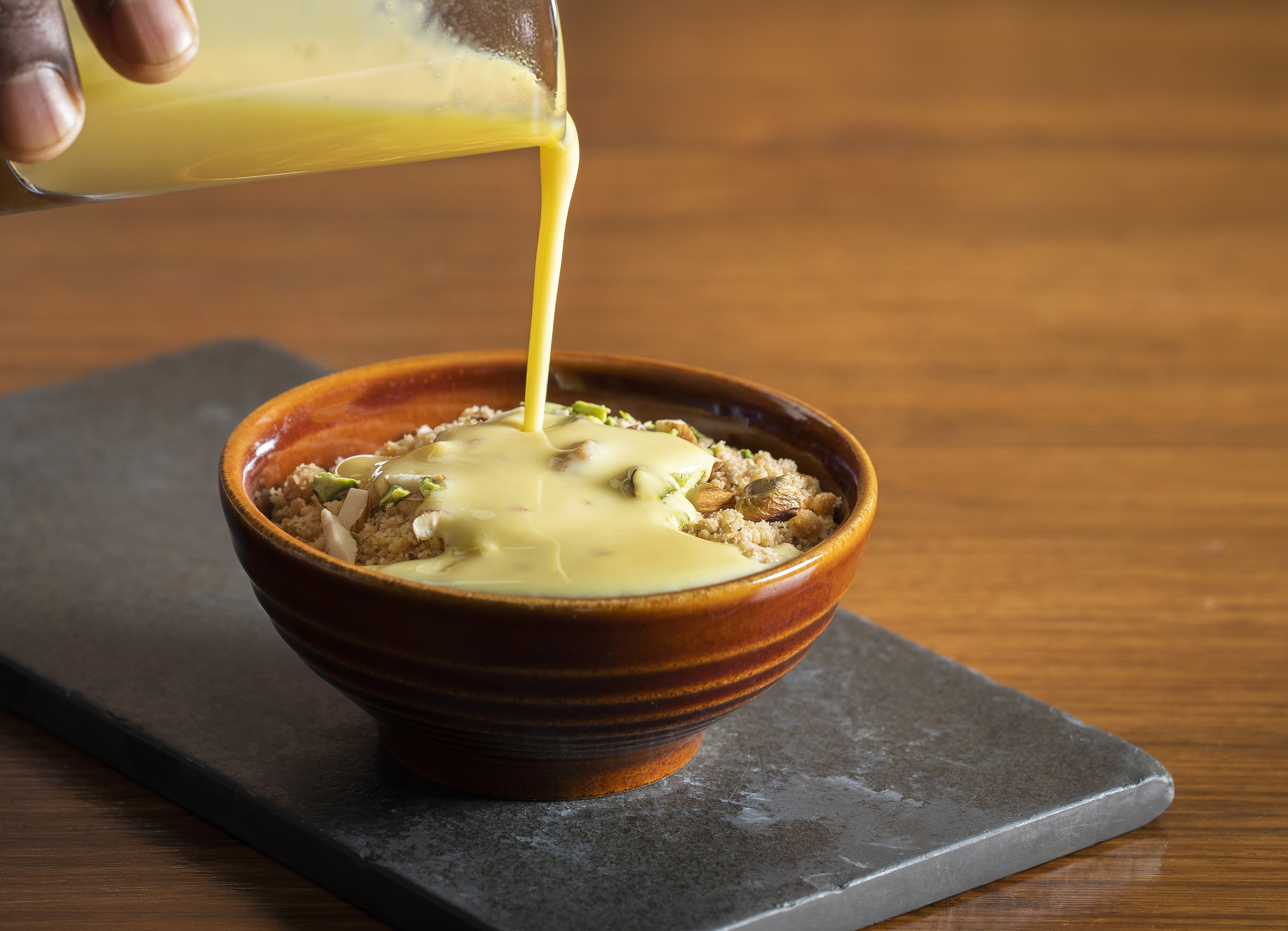 Dessert drizzled with sauce at Babur's Marquee, perfect for catering events.