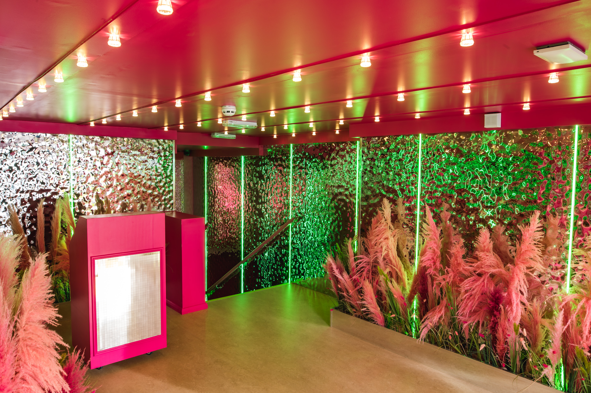 Vibrant event space at Tonight Josephine Bristol with pink walls, ideal for gatherings.