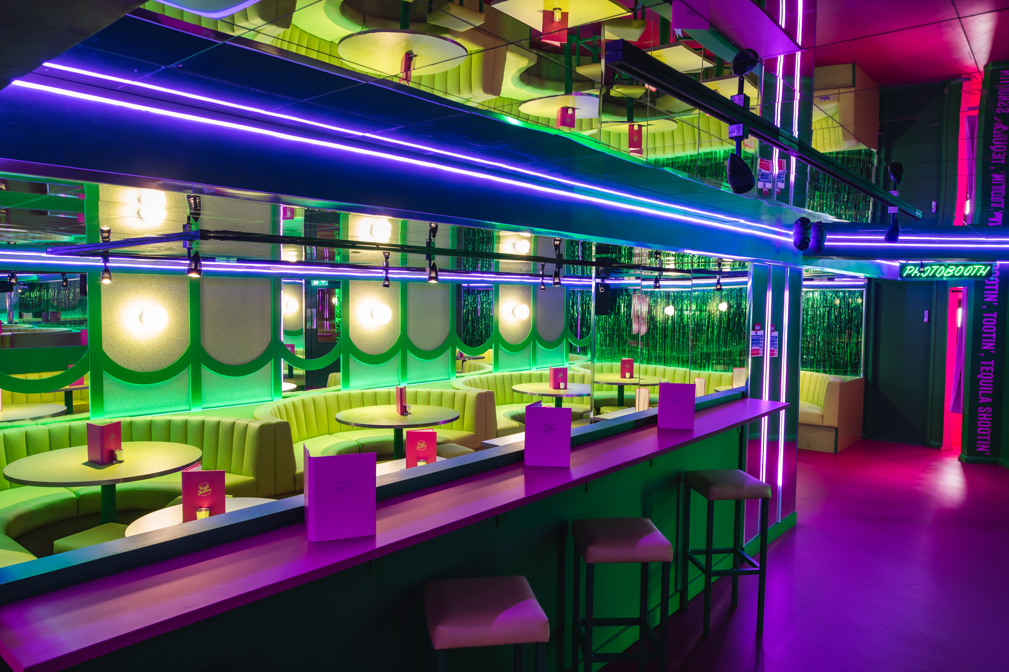 Vibrant event space at Tonight Josephine Bristol with neon lighting for social gatherings.