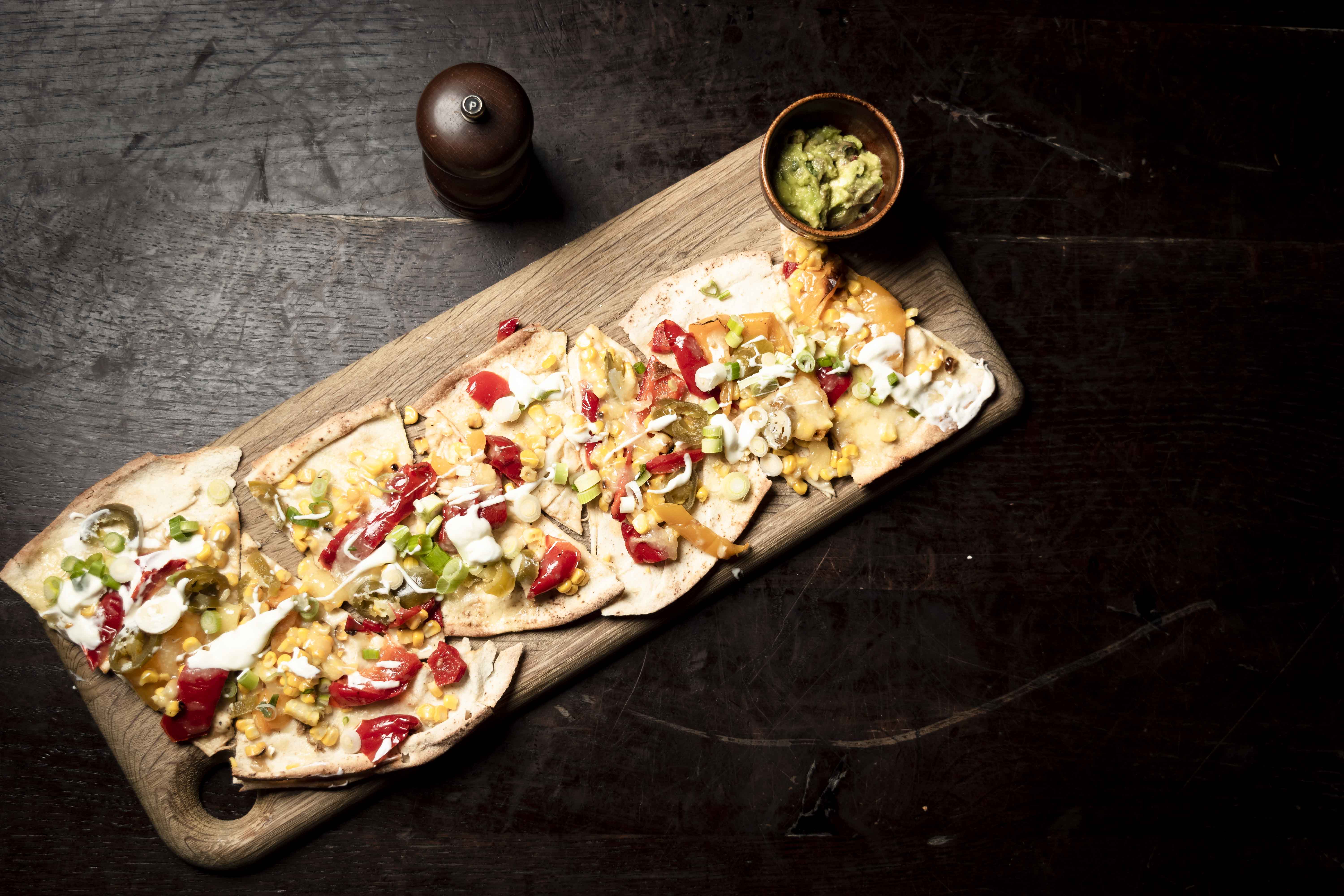 Vibrant nacho platter for casual networking events at Topolski venue.