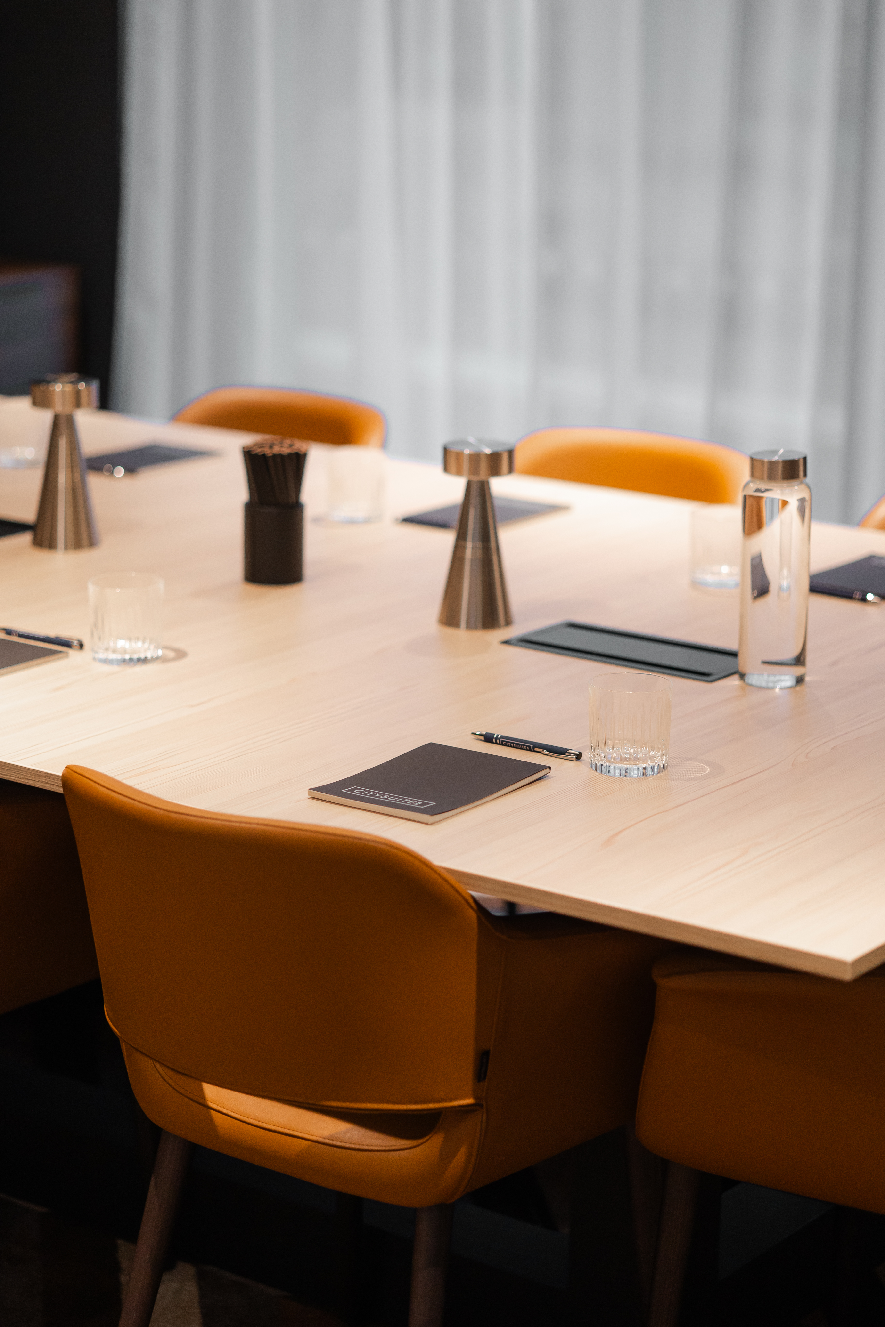 Meeting Room in CitySuites II with sleek wooden table, ideal for professional events.