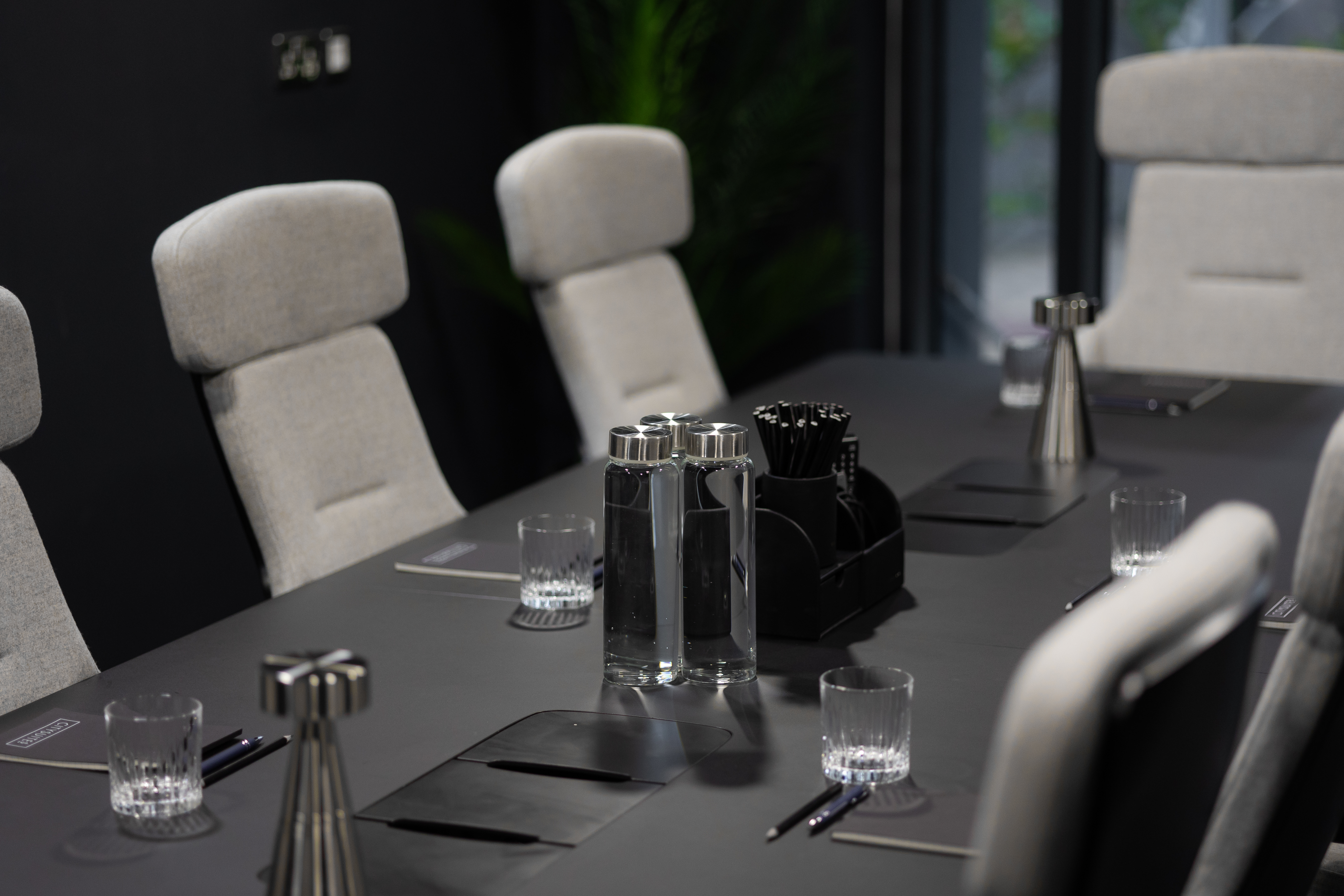 Modern conference room with dark table, ideal for professional meetings and collaboration.