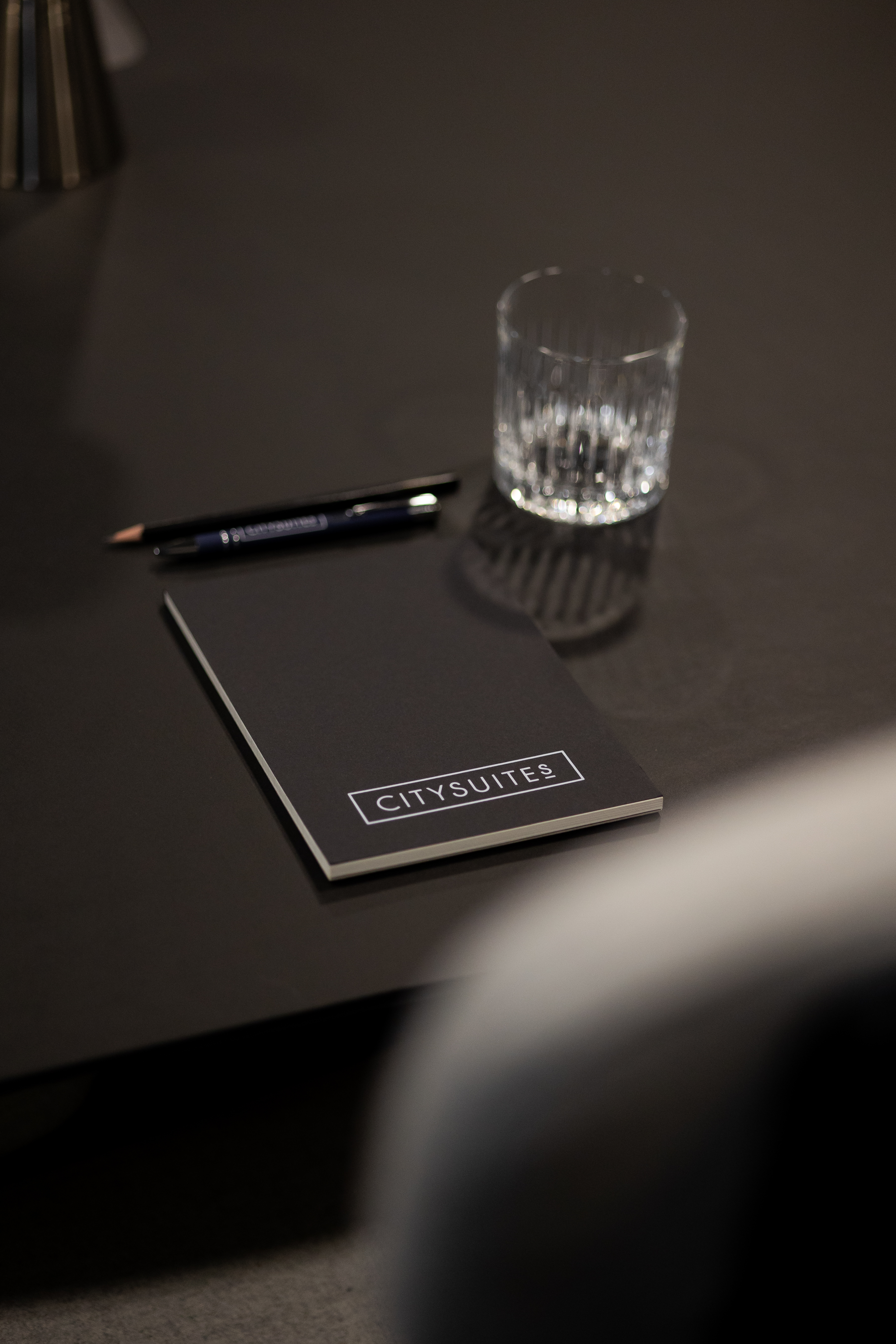 Conference Room in CitySuites II with branded notepad, ideal for professional meetings.