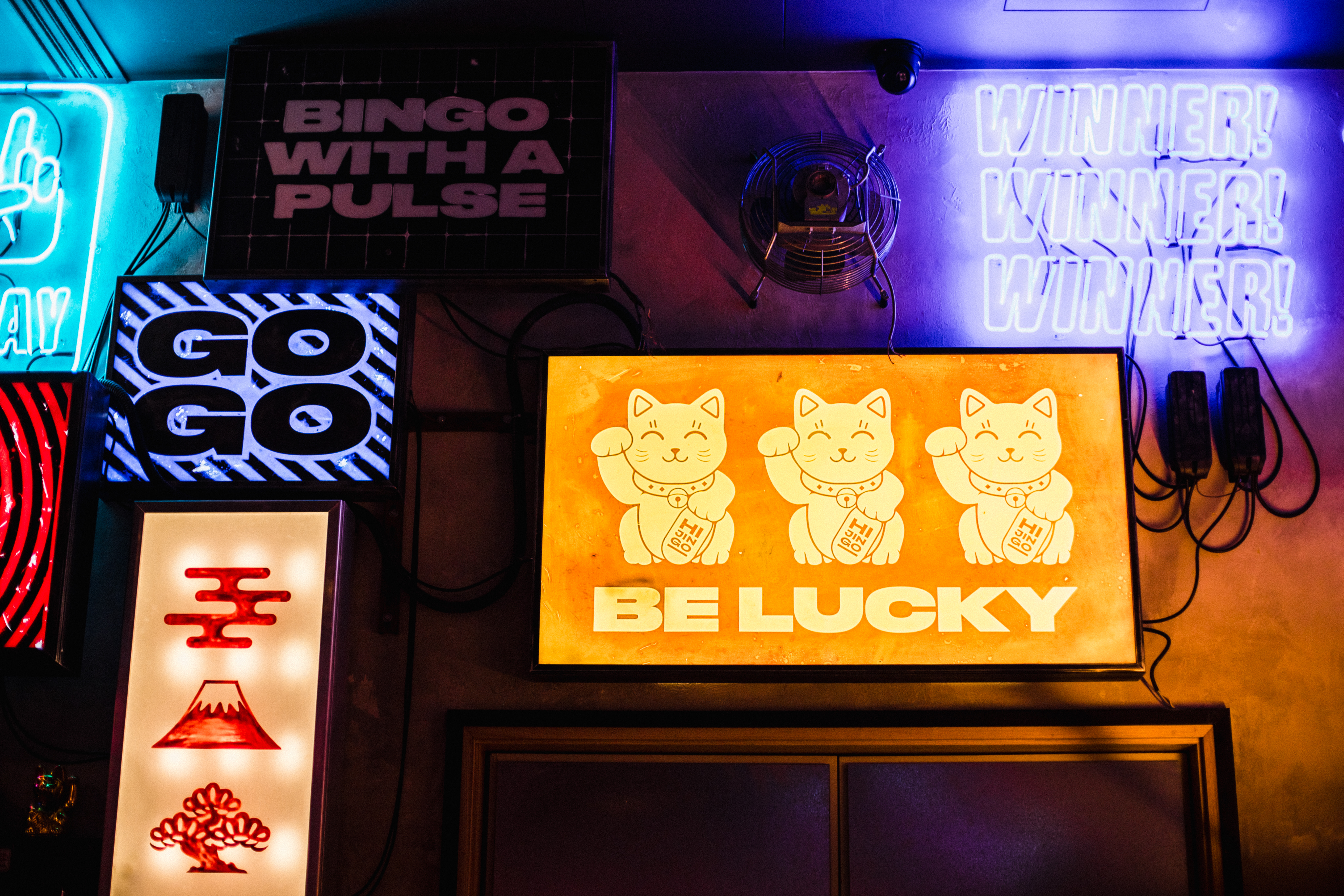 Vibrant Lucky Cat Bar with neon signs, perfect for themed parties and social gatherings.