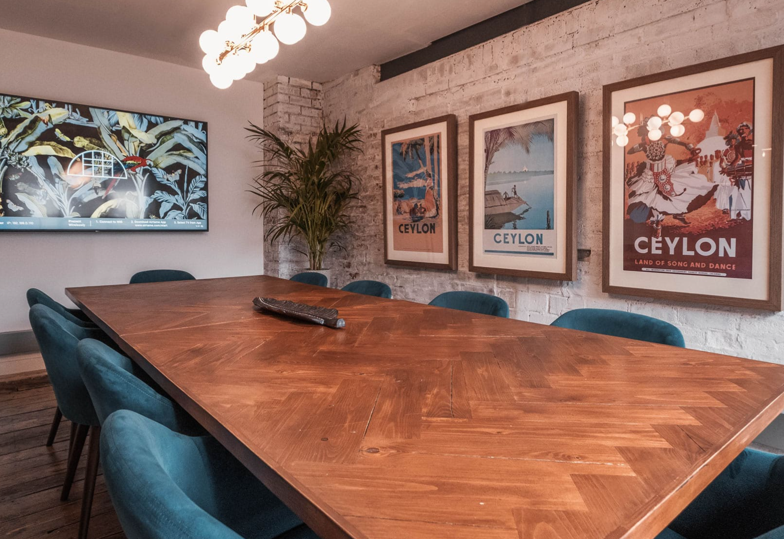 Modern meeting room at Beehive Mill with wooden table, ideal for collaboration and brainstorming.