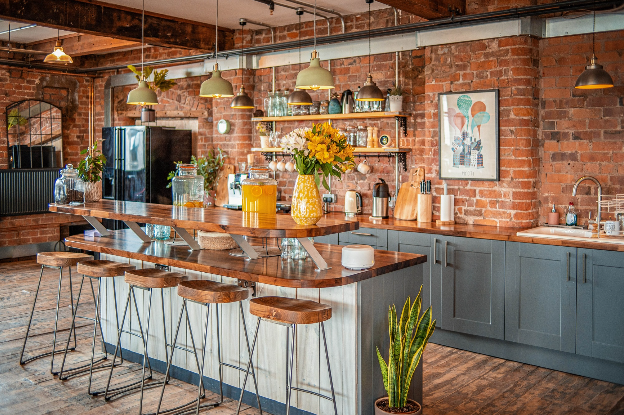 Modern kitchen in Beehive Mill with exposed brick, ideal for events and gatherings.