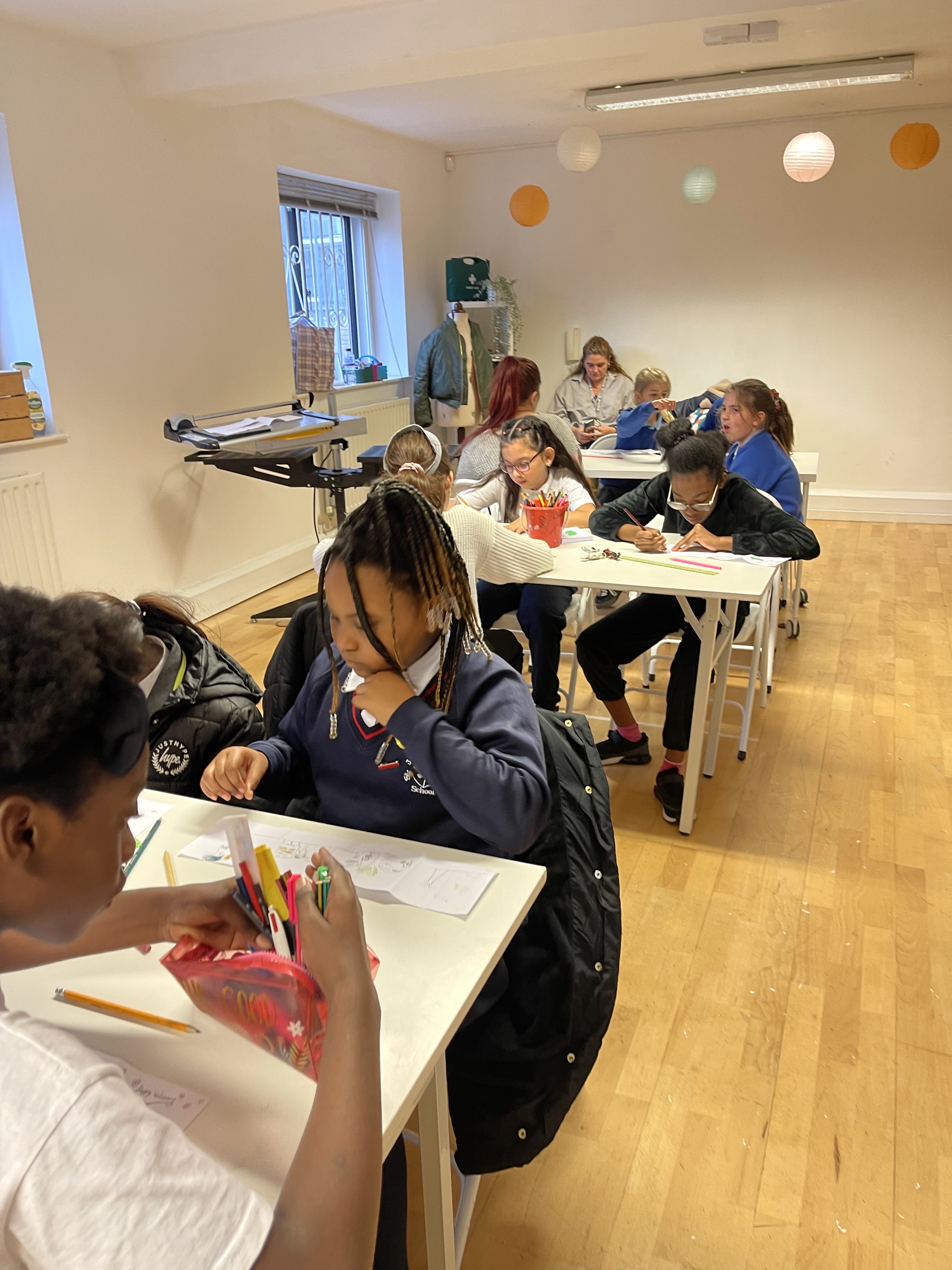 Children engaged in creative activities in a collaborative classroom at The Bop Hub.
