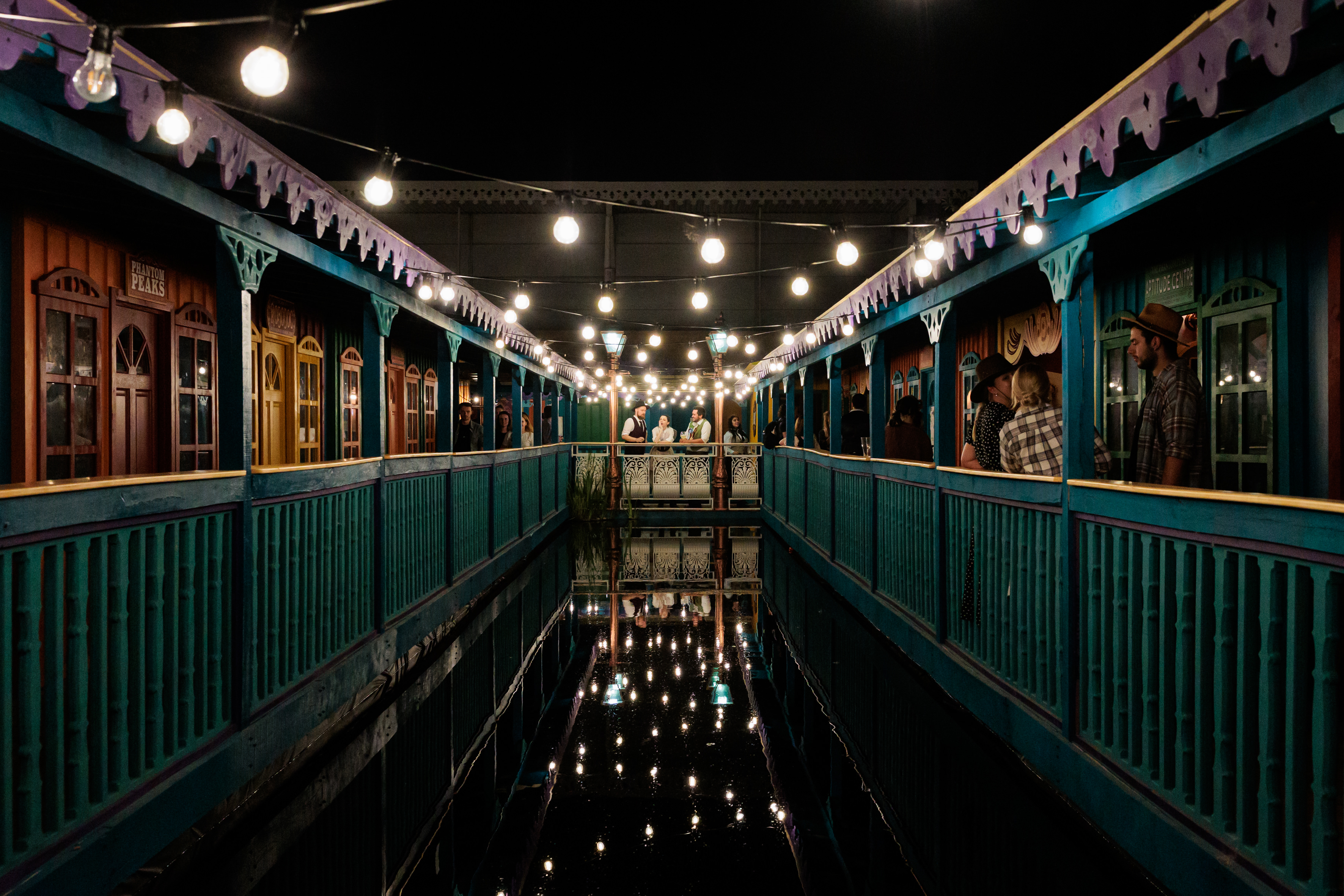 "Phantom Peak outdoor venue with colorful structures and string lights for evening events."