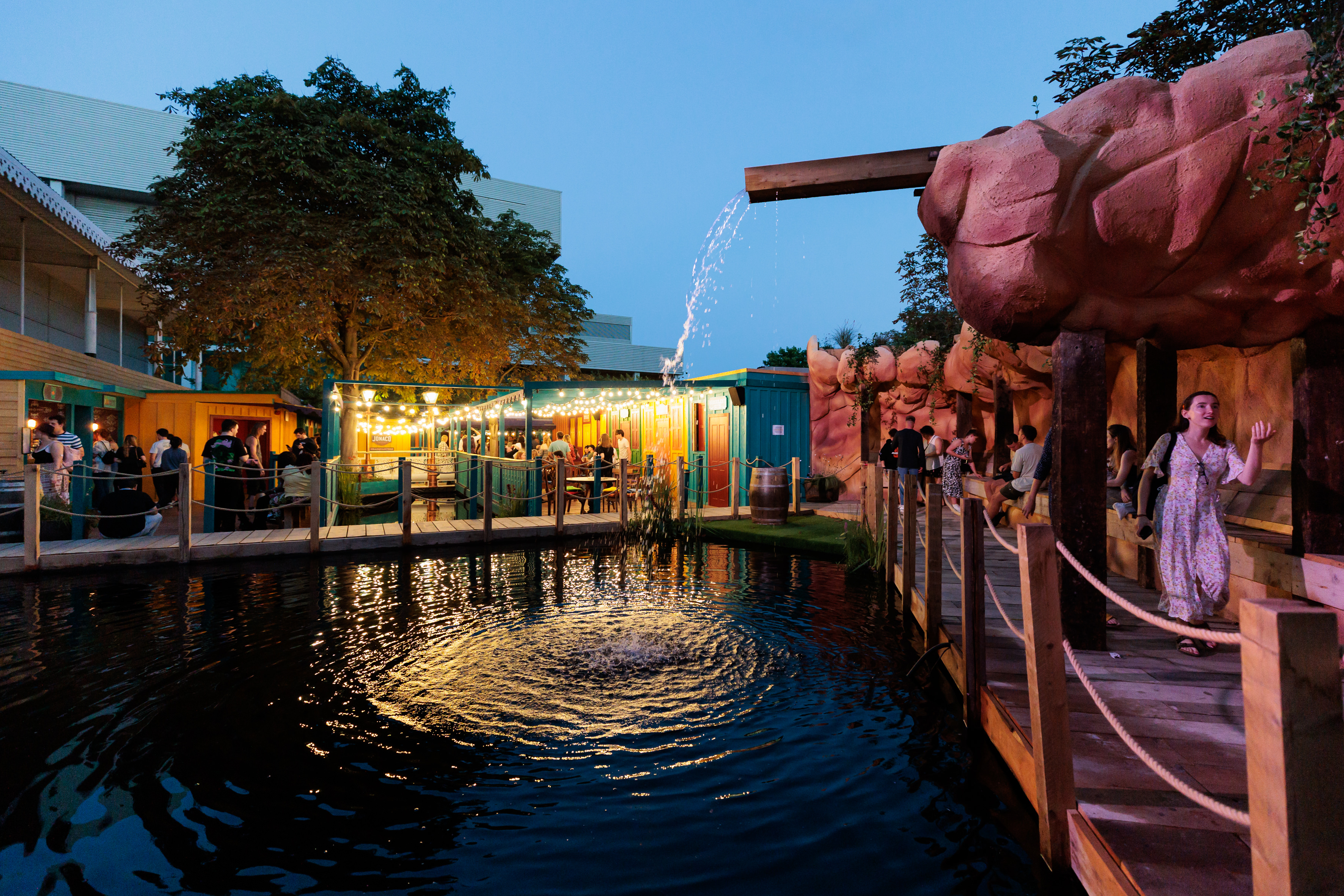 Vibrant outdoor event space at Phantom Peak with scenic water feature for gatherings.