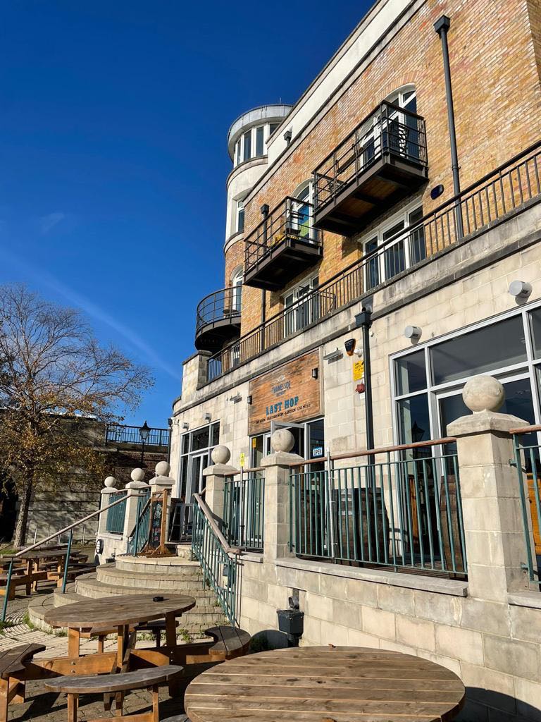 Stylish Main Bar at Last Hop with outdoor terrace, ideal for events and gatherings.