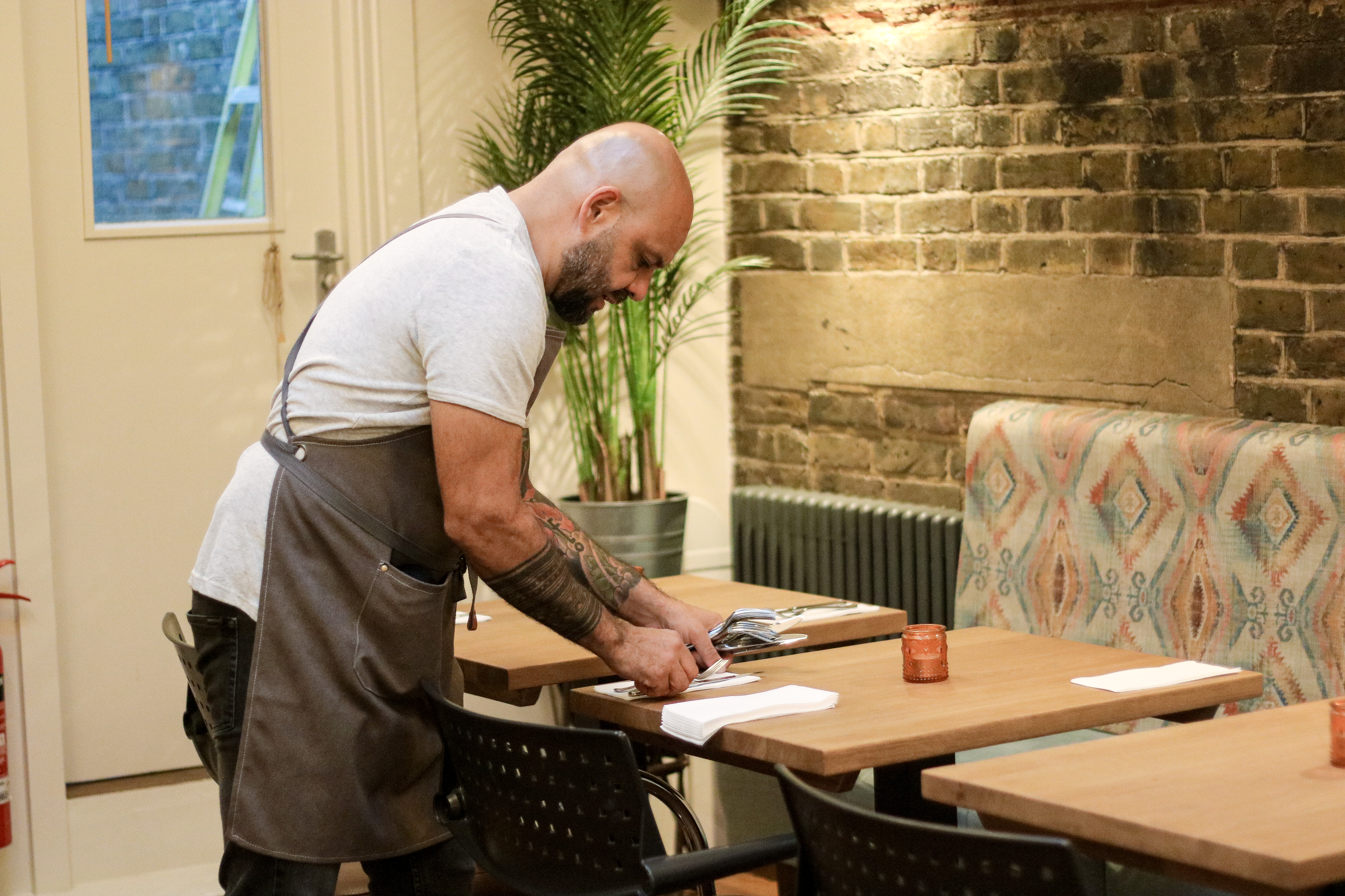 Private dining room at Bell & Viv, featuring organized tables for events and rustic decor.
