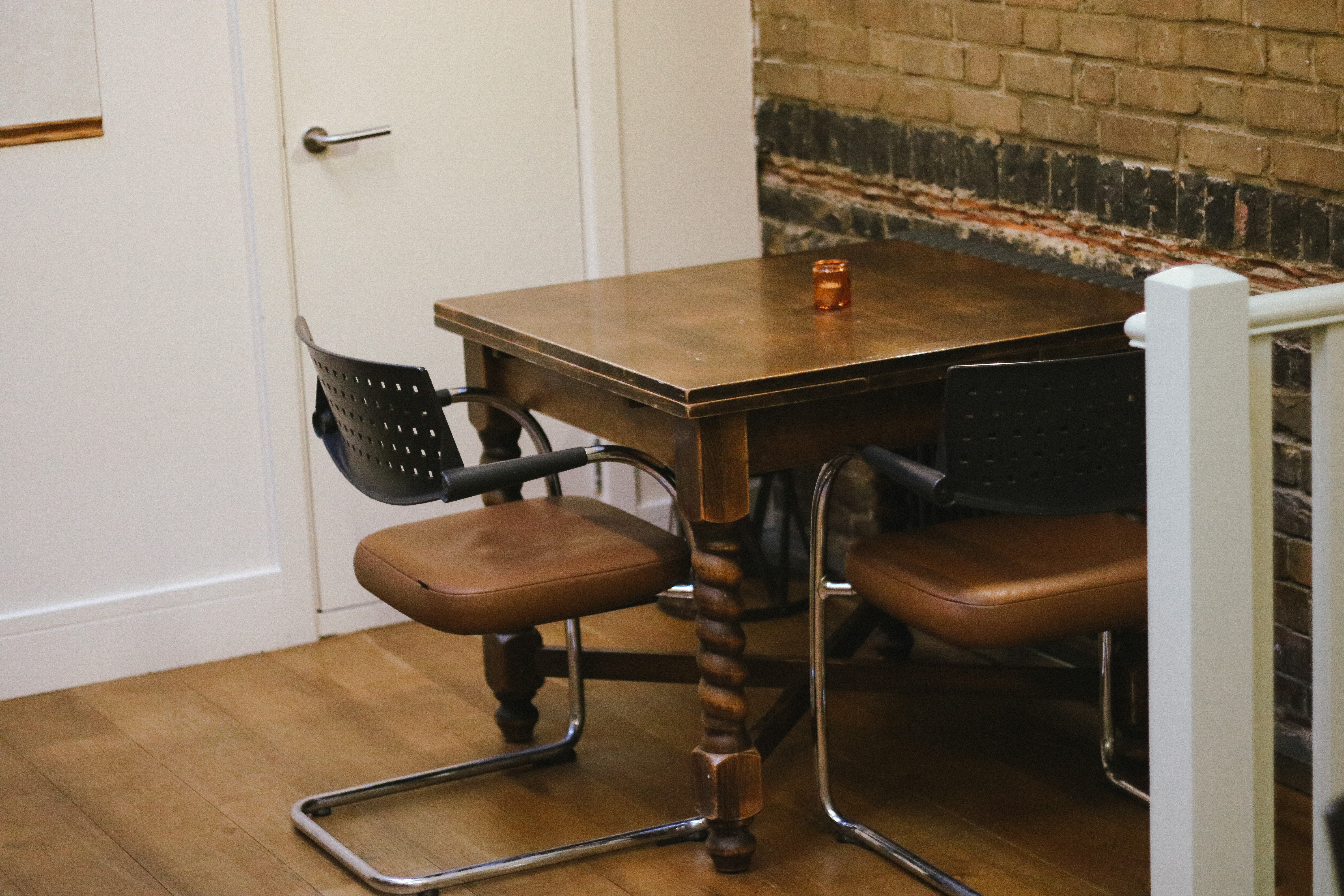 Cozy private dining room with rustic table, ideal for meetings and client consultations.