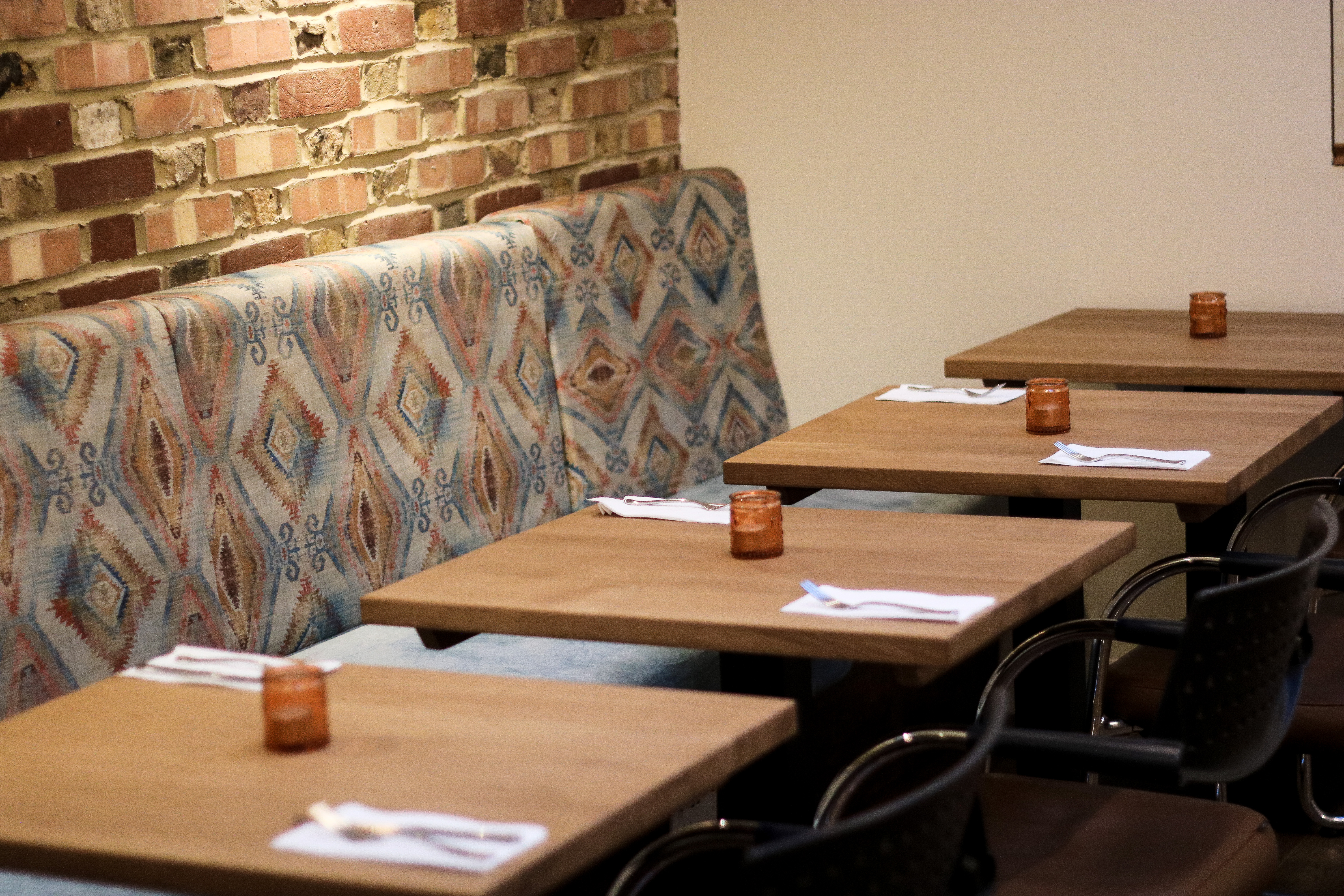 Cozy private dining room with wooden tables, perfect for intimate gatherings and networking events.