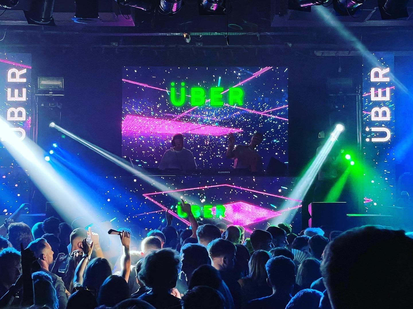 Vibrant Main Hall event at The Venue Carlisle with dynamic lighting and Uber branding.