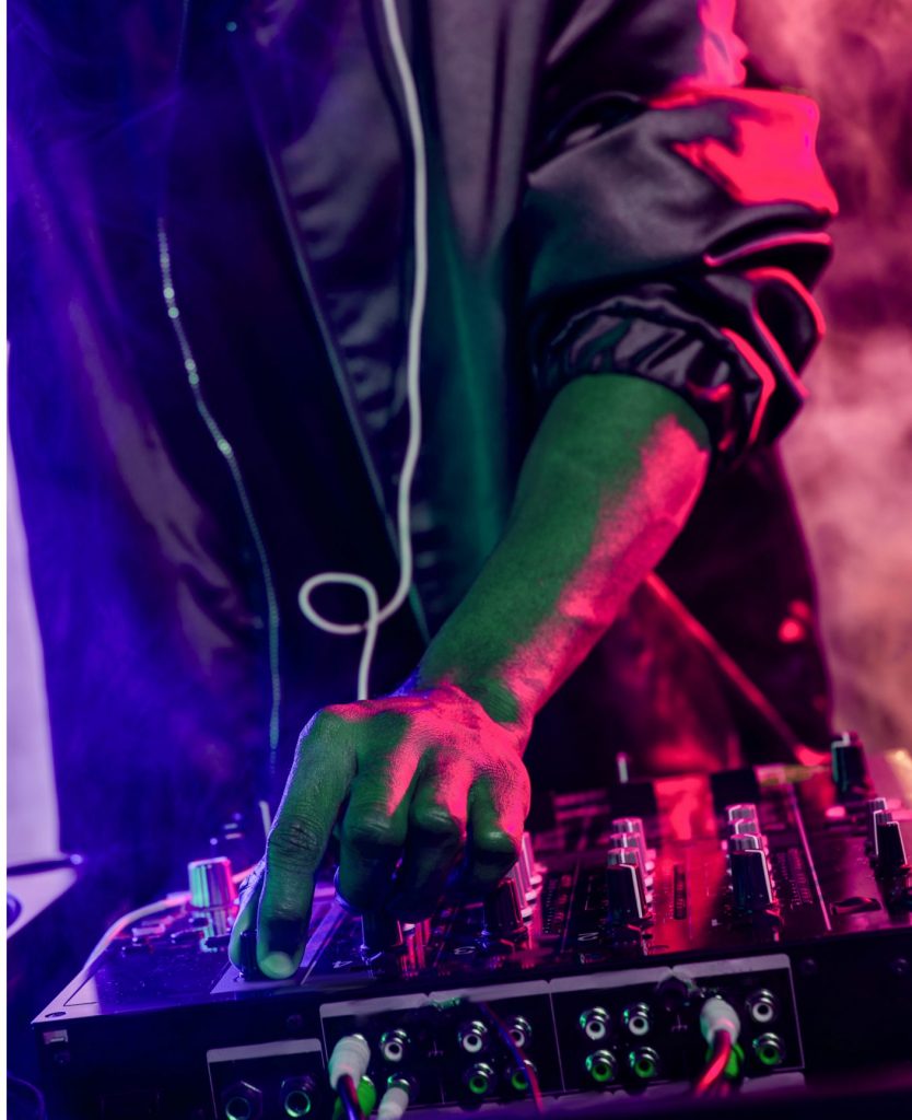 DJ mixing tracks in vibrant 'LA' Studio, perfect for parties and corporate events.