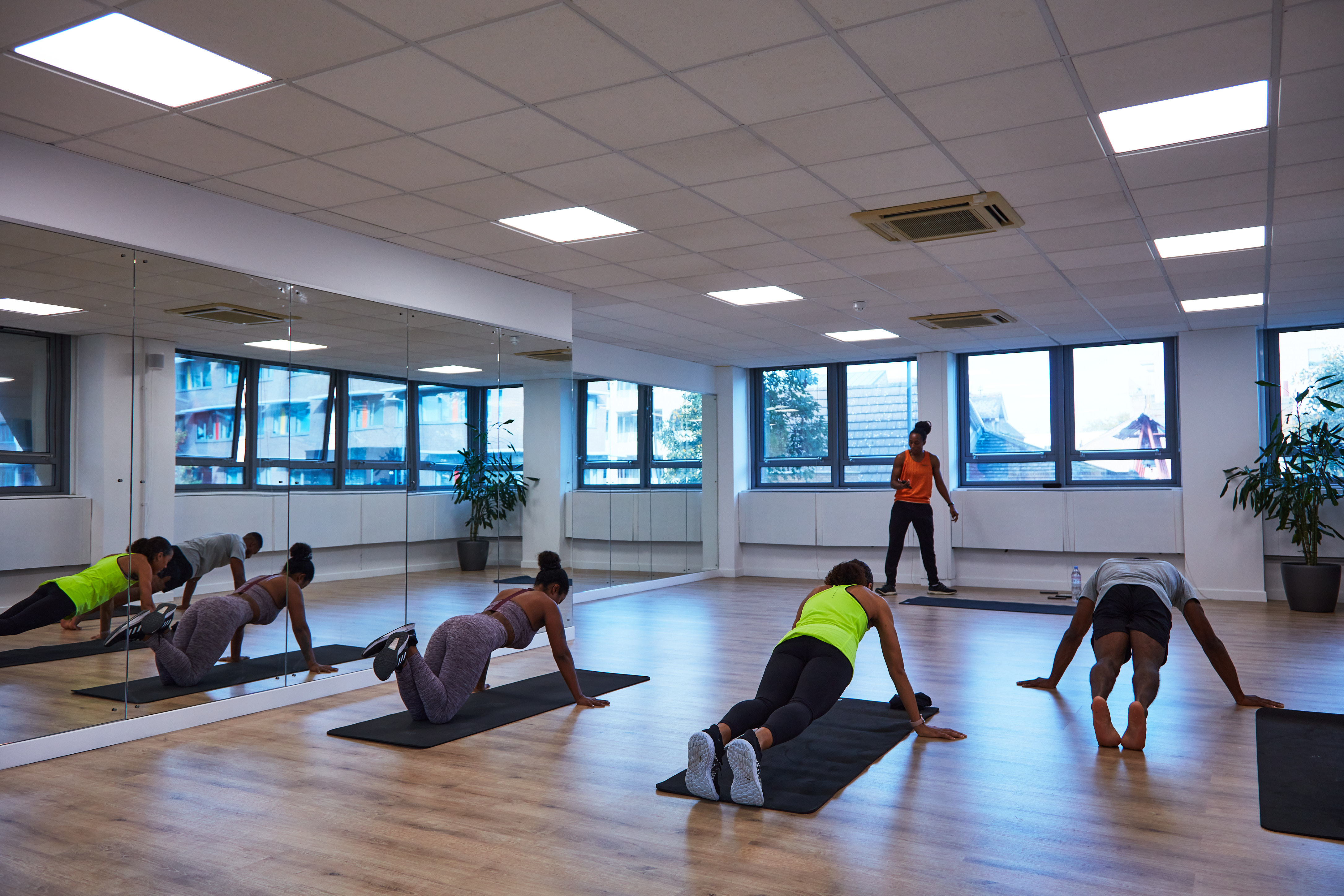 Dynamic fitness class in a bright wellness studio for event planning and networking.