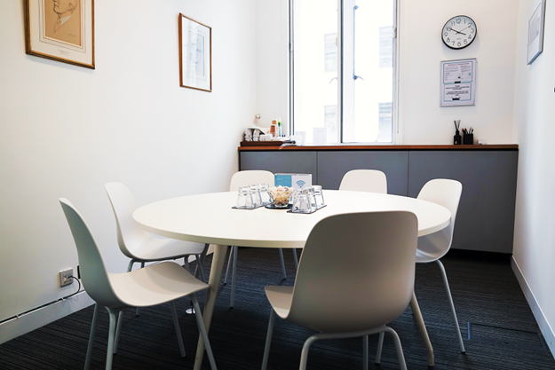 Modern small meeting room with round table for productive brainstorming sessions.