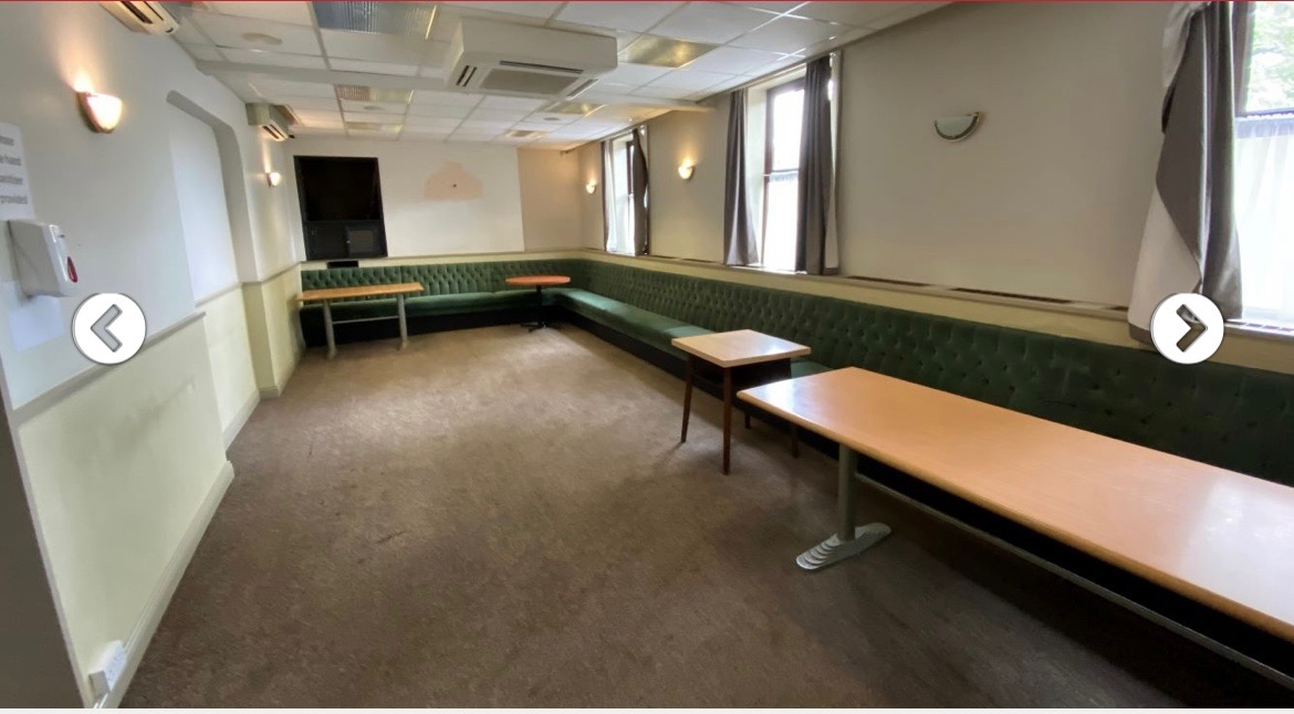 Versatile meeting space at Banbury Trades and Labour Club with green seating for workshops.