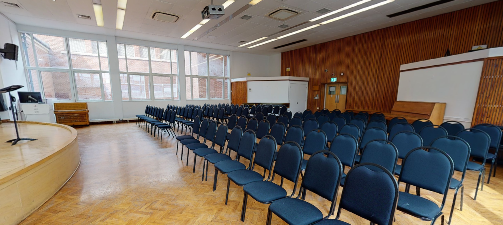 Recital Hall at Royal College of Music with blue chairs for presentations and lectures.