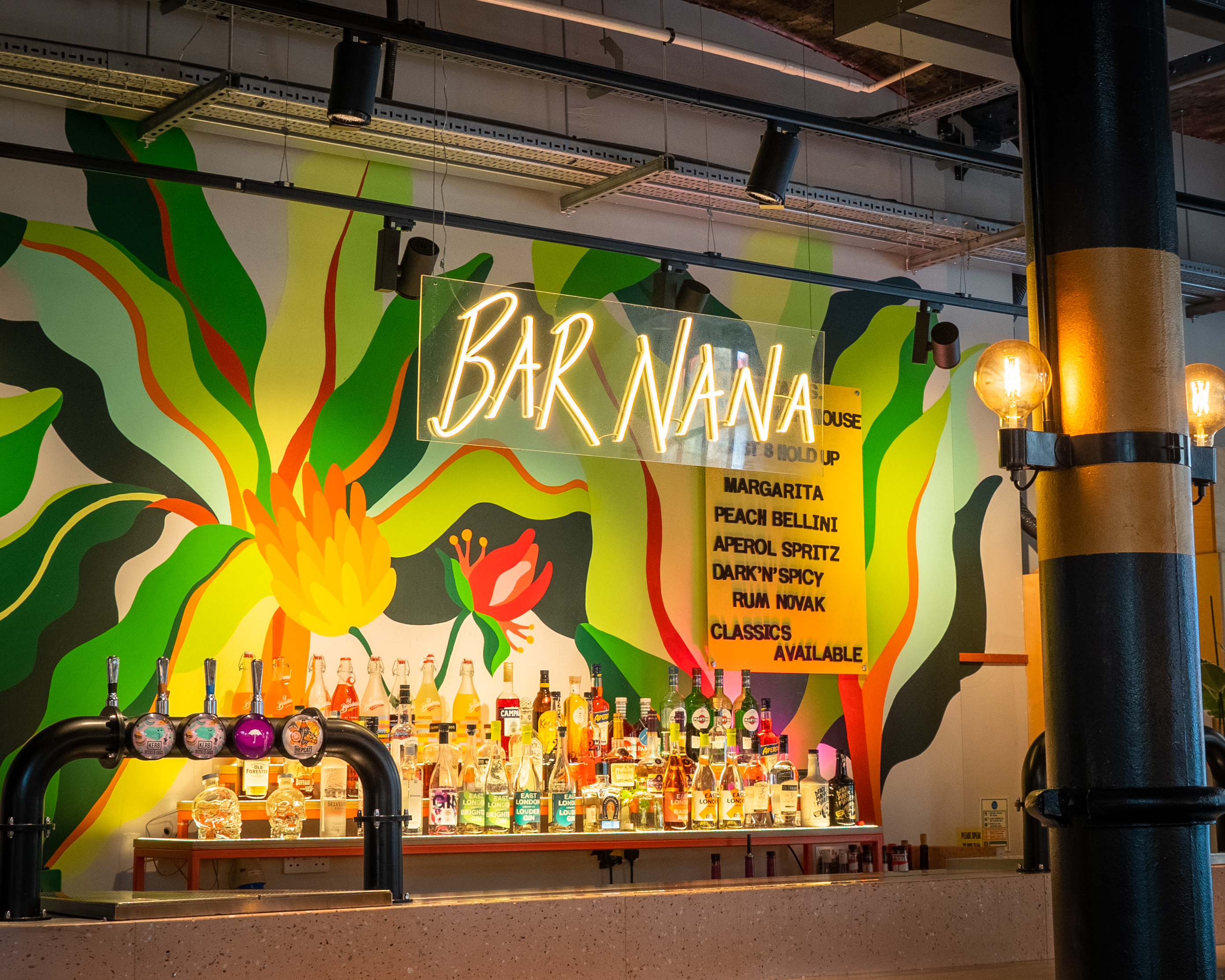 Vibrant Bar Nana at Seven Dials Market with colorful mural for social events.