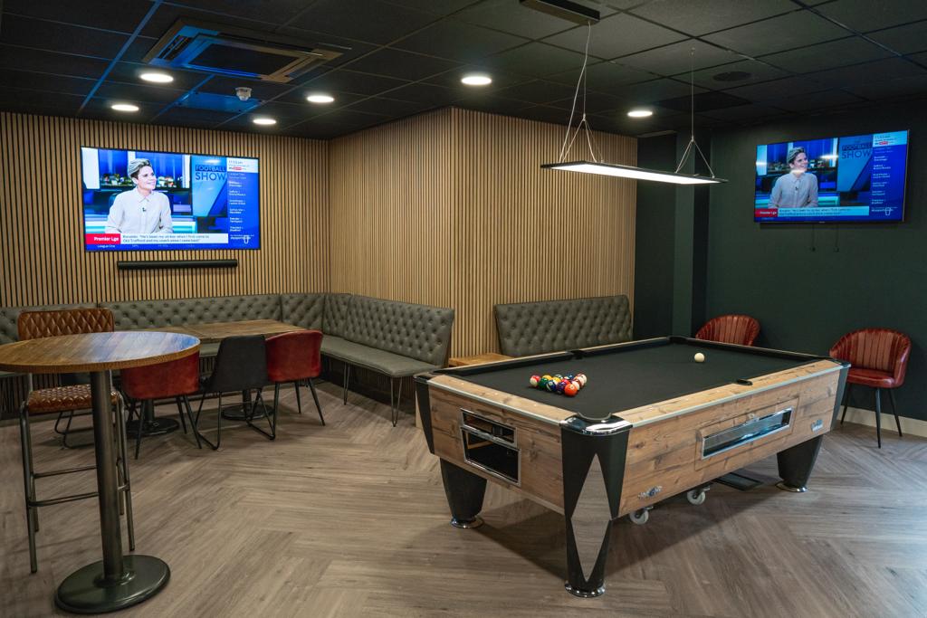 Modern lounge with pool table at PSA Performance Centre for networking and conferences.