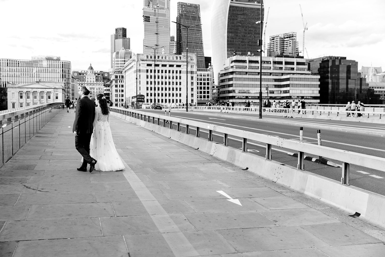 Newlyweds on a city bridge at Glaziers Hall, perfect for urban wedding events.