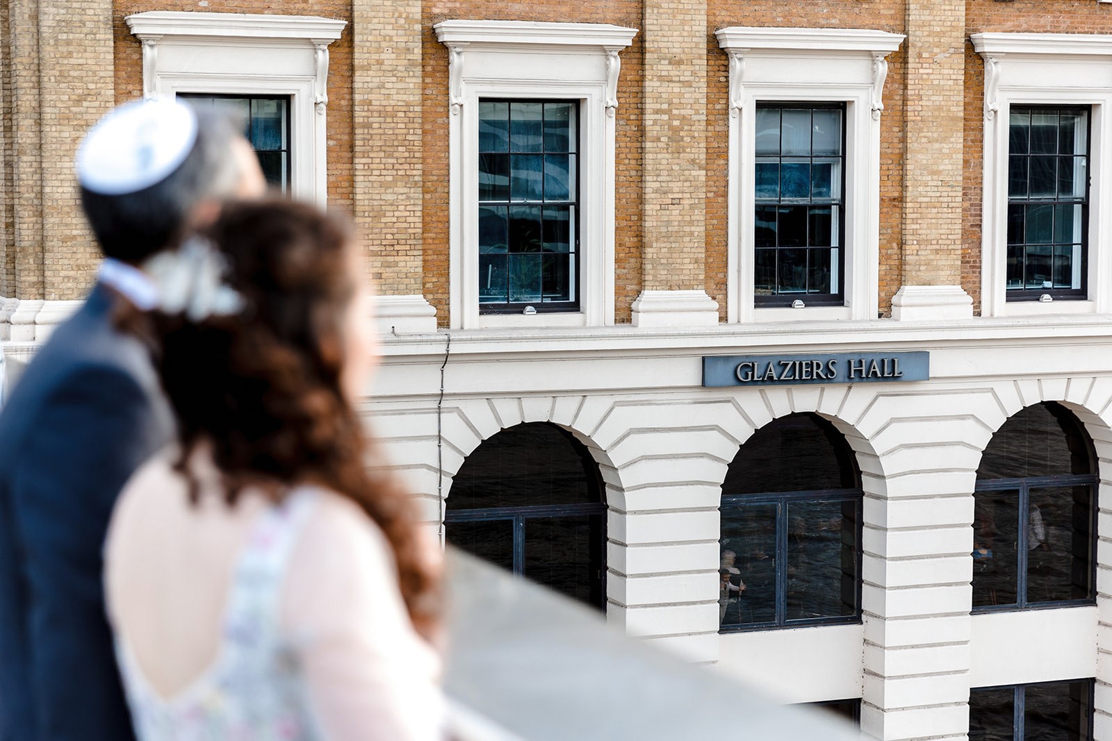 Couple overlooking Glaziers Hall, an elegant wedding venue for memorable celebrations.