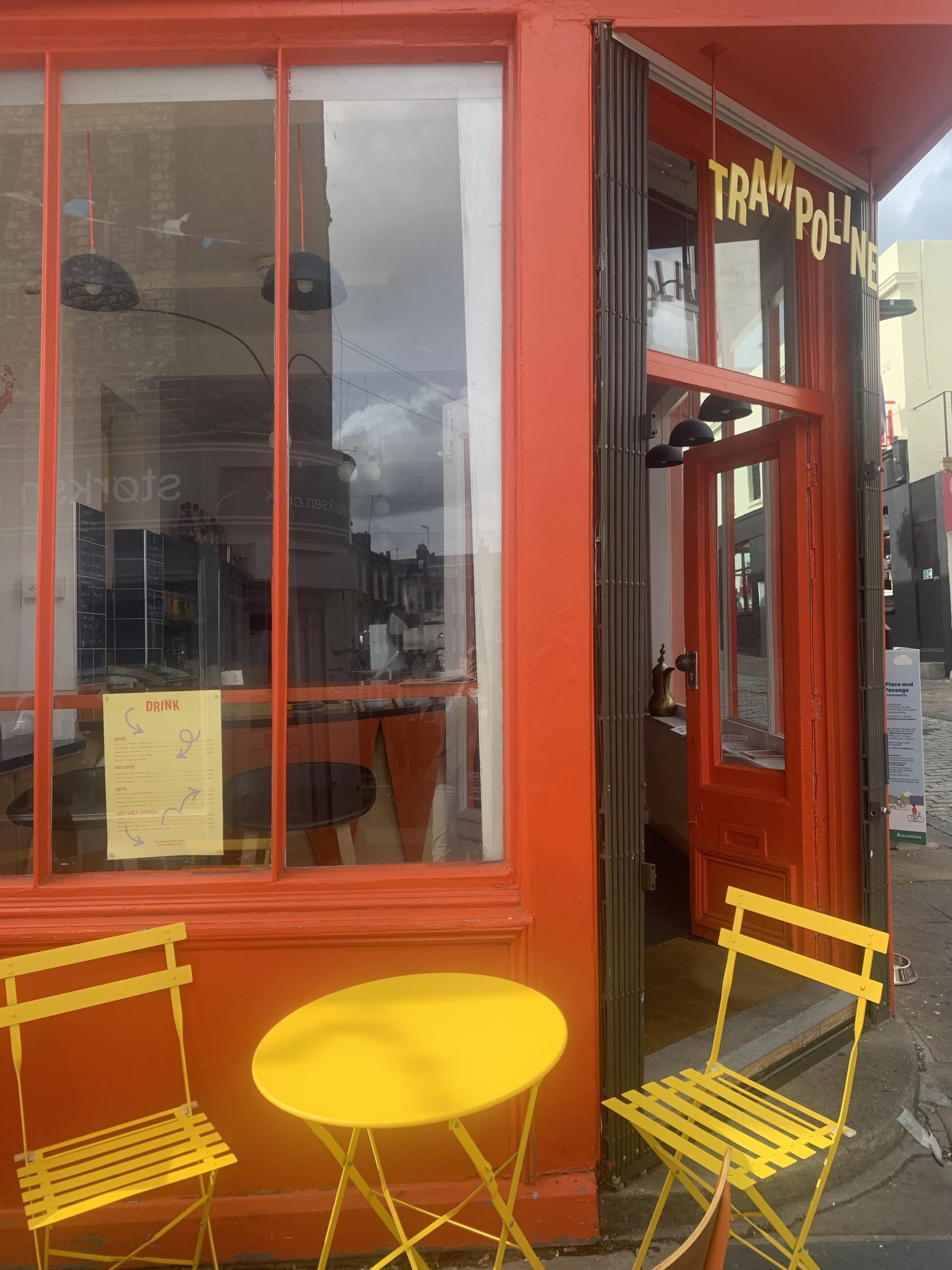 Vibrant trampoline venue entrance with bold orange doors for events and gatherings.