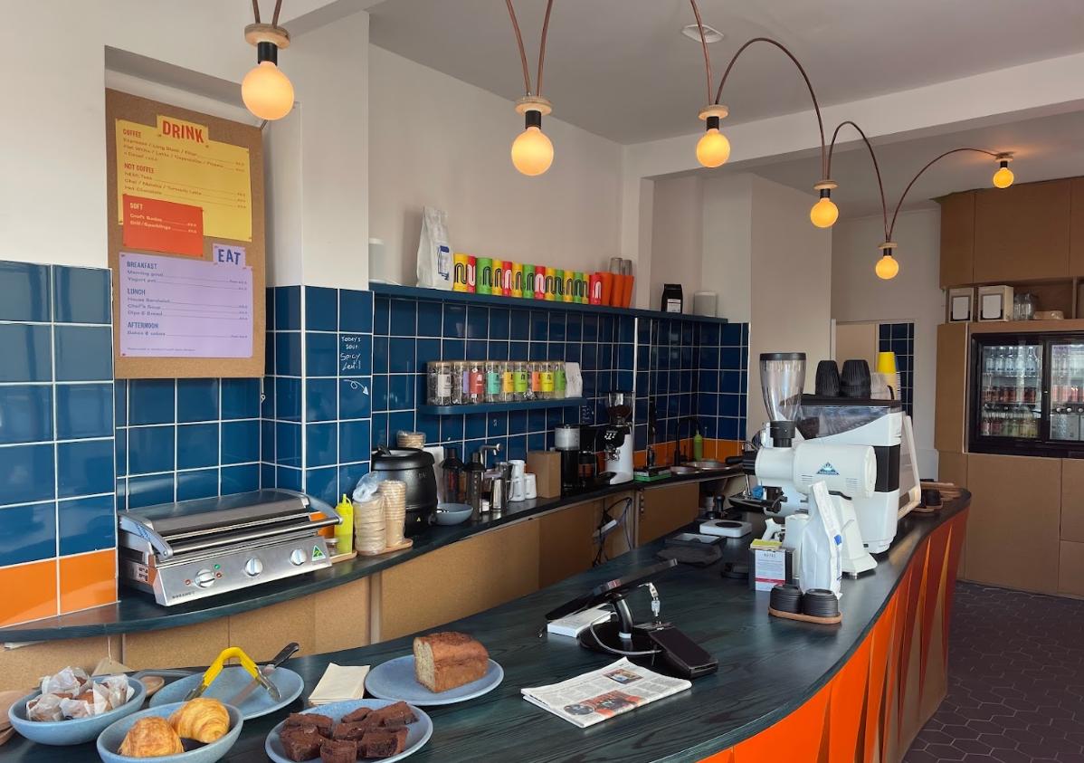 Modern café venue with vibrant decor, ideal for networking events and casual meetings.