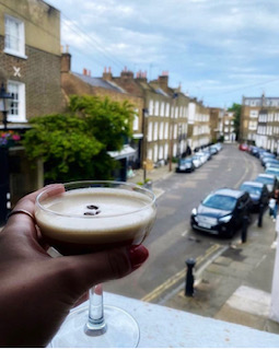 Outdoor cocktail reception with coffee bean drink at a charming venue.
