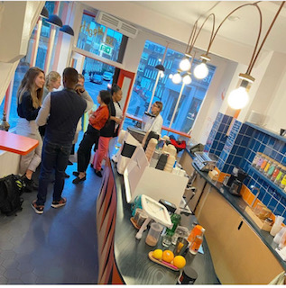 Vibrant networking event in modern café with attendees engaged in conversation.