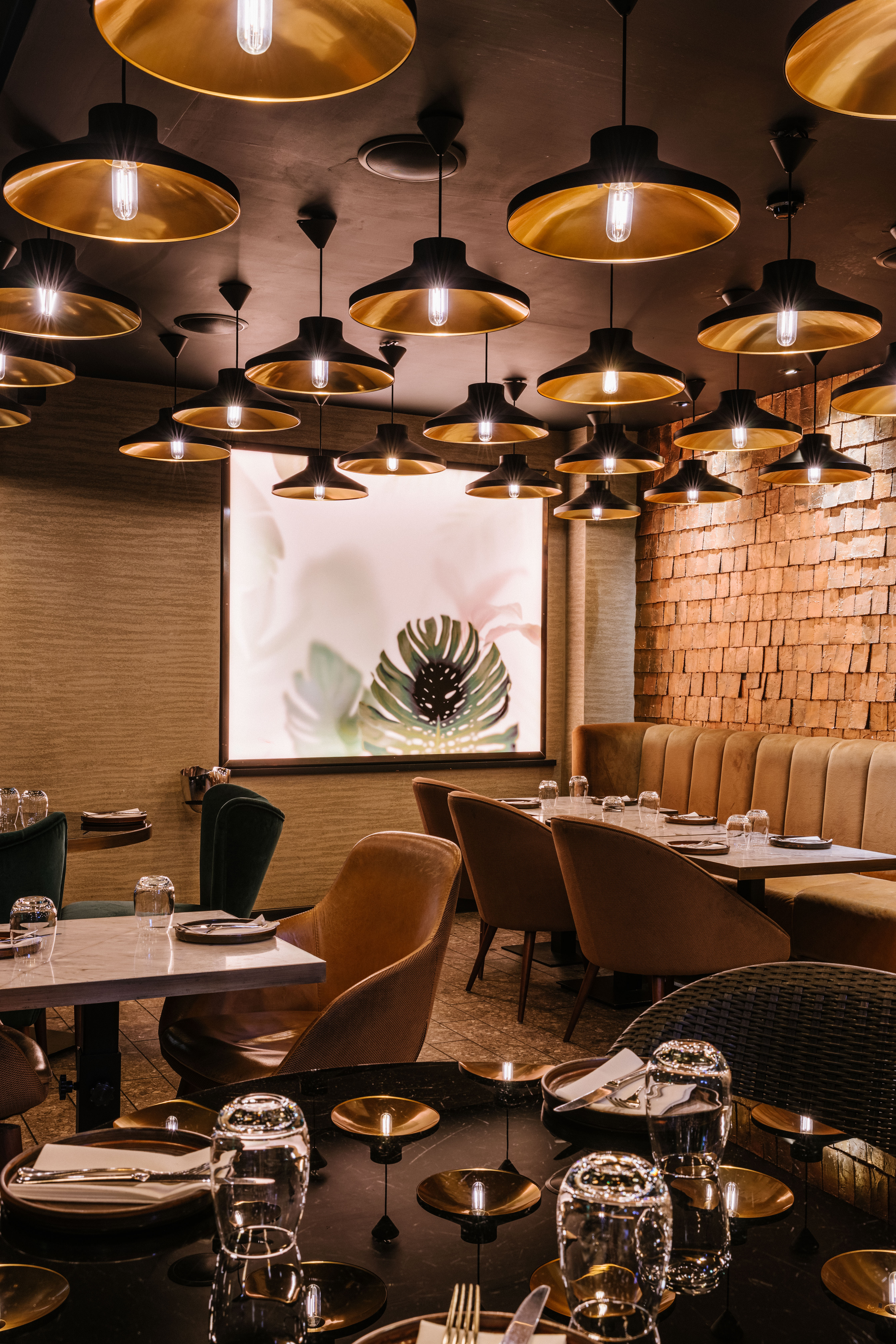 Stylish restaurant interior with booth seating at Farzi London, perfect for intimate events.