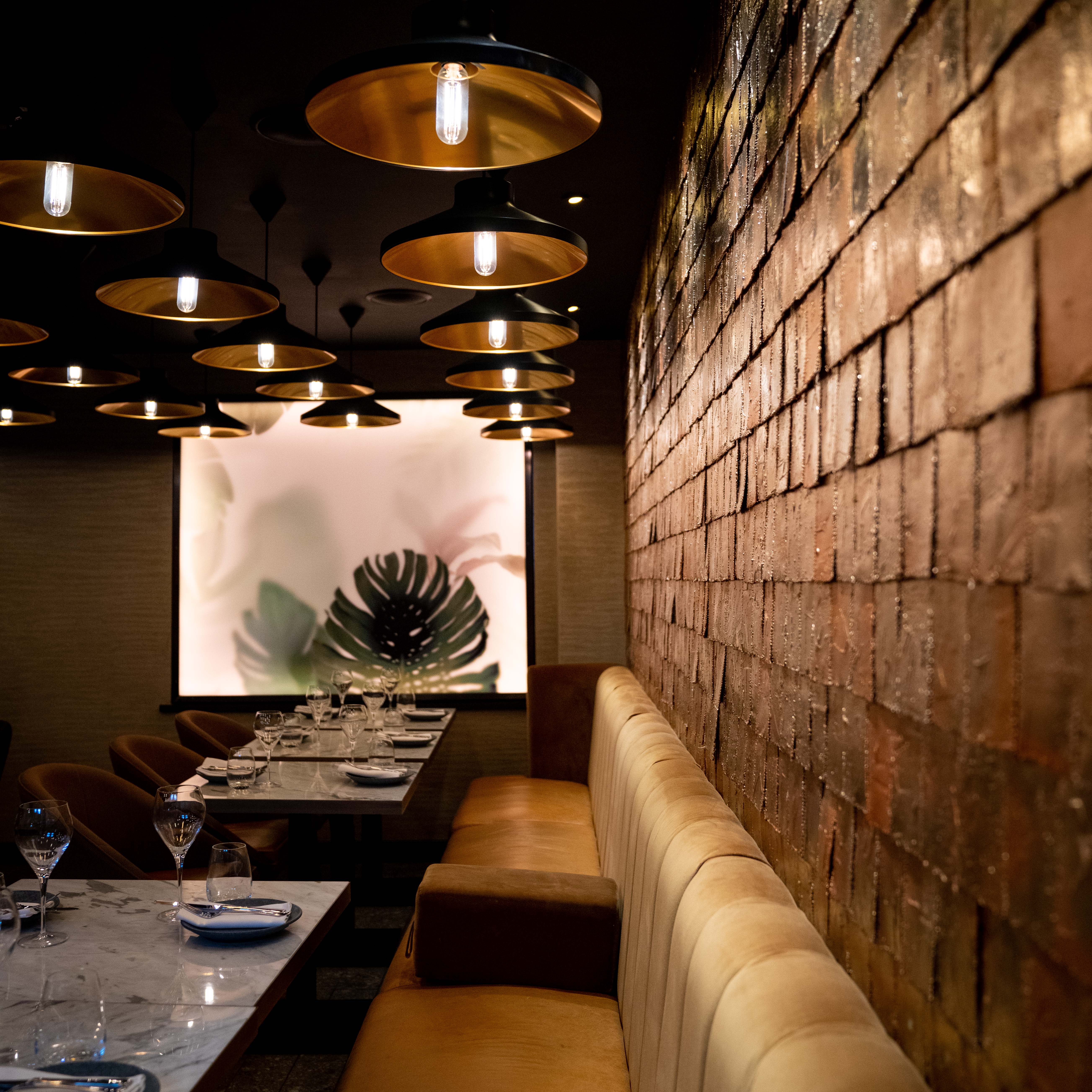 Stylish dining space in Farzi London with warm lighting, perfect for events and gatherings.