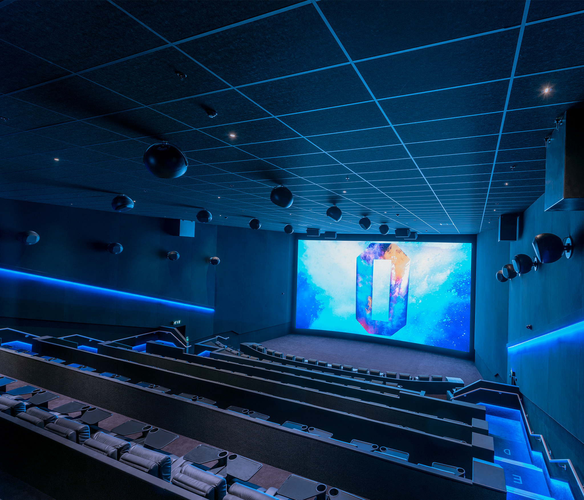 Modern cinema space with large screen for corporate events and presentations.