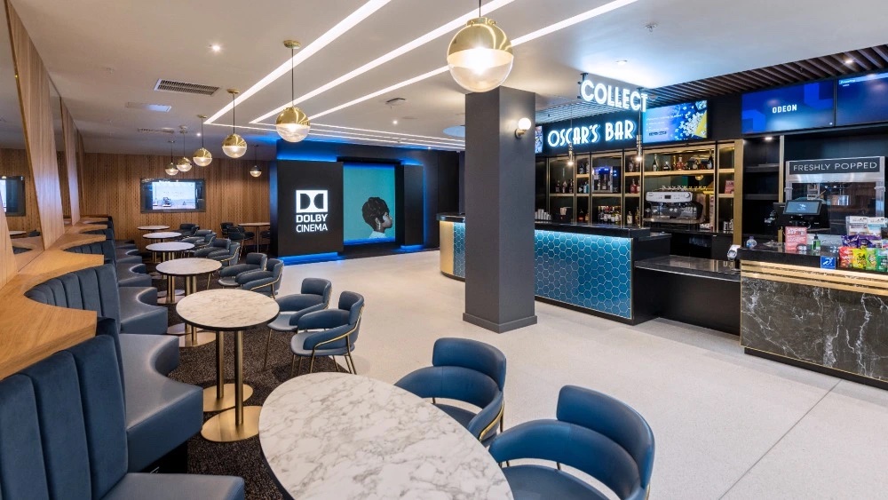 Modern event space at ODEON Luxe West End with stylish bar and ambient lighting.