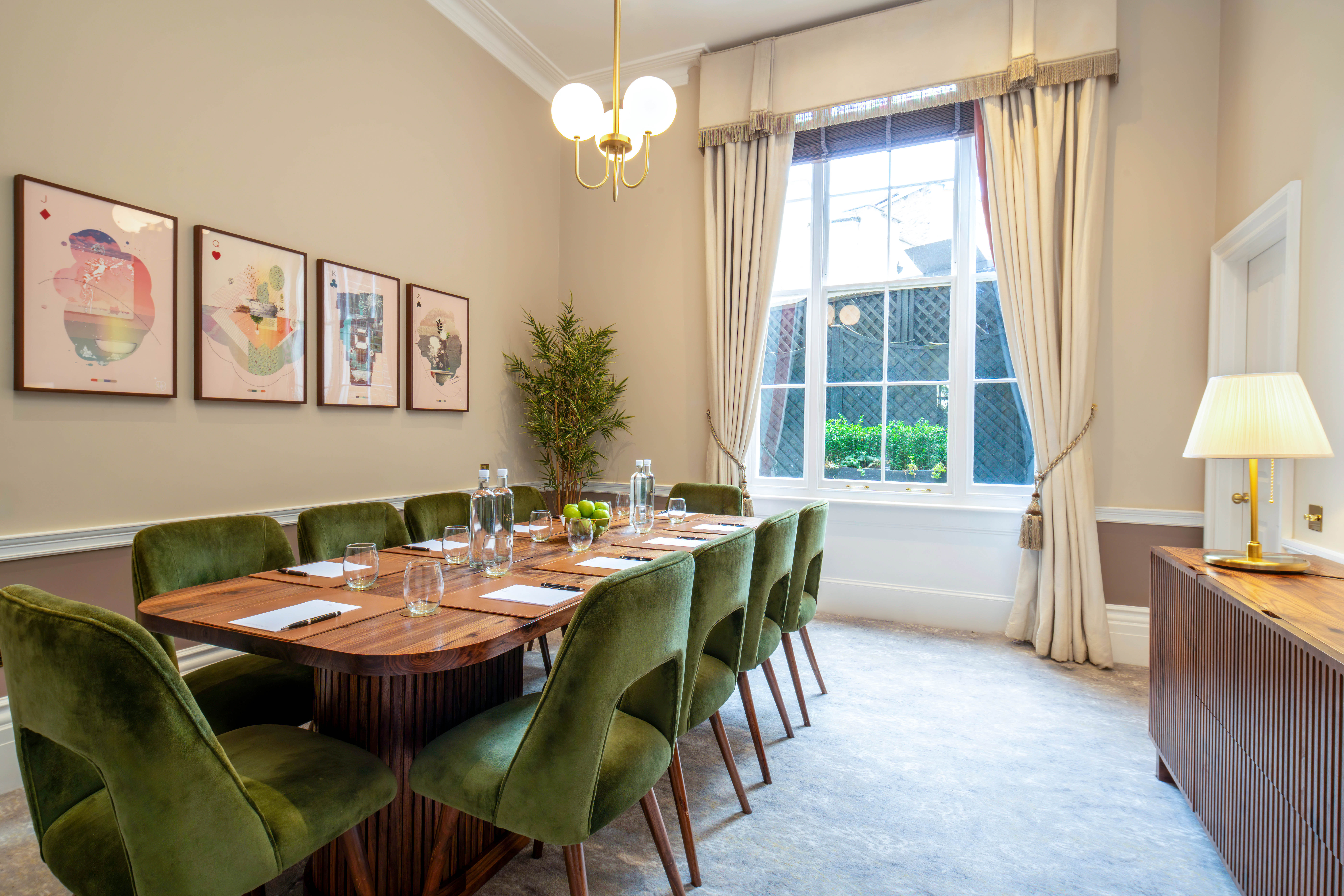Elegant meeting room with wooden table and plush chairs for intimate gatherings.
