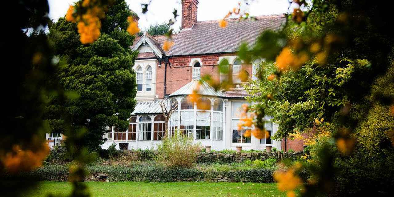 Charming Berrow Court venue with lush greenery, ideal for meetings and events.