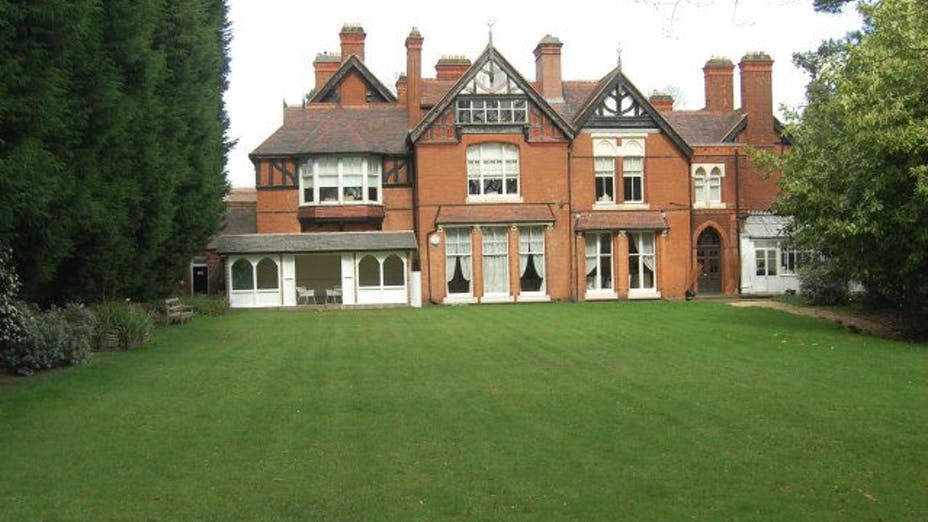 Historic Berrow Court venue with expansive lawn for corporate retreats and elegant events.