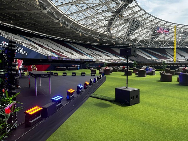 Vibrant event setup at The Deck, London Stadium with stylish lounge seating and colorful lighting.