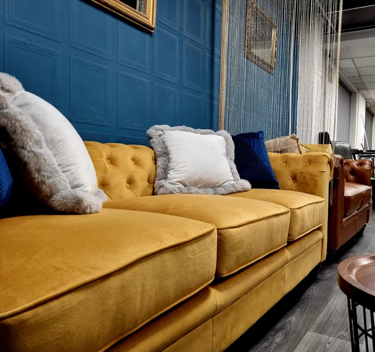 Stylish yellow couch in Al-Miski Lounge for networking events and informal meetings.