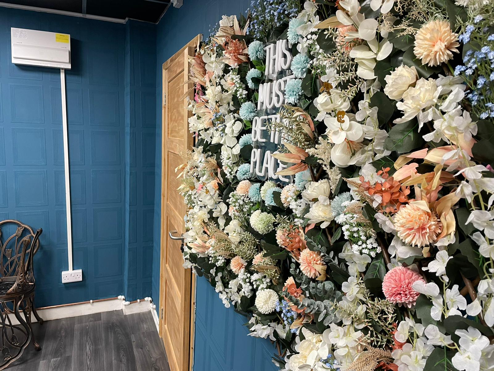 Al-Miski Lounge floral backdrop, vibrant decor for events and gatherings.