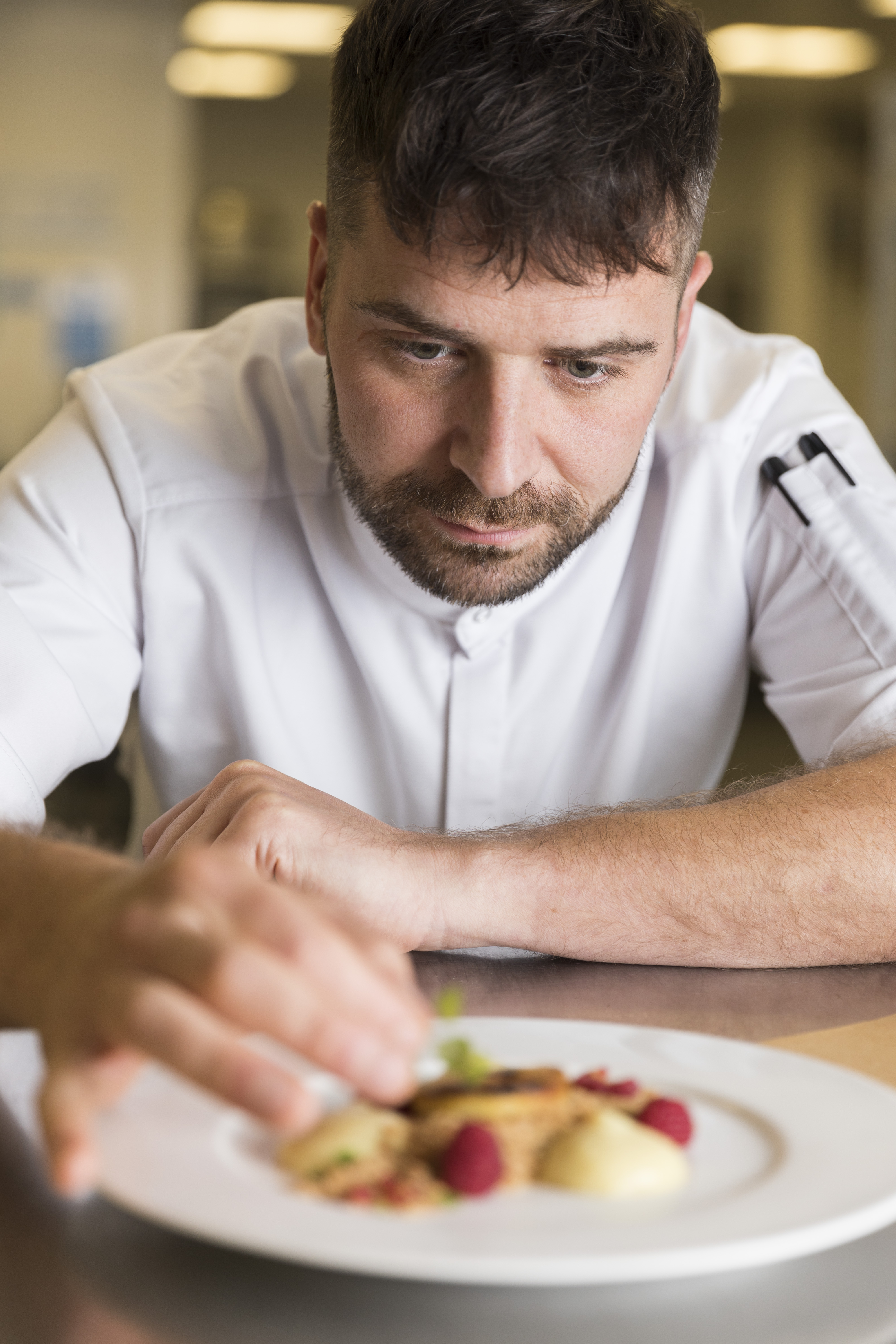 Professional chef focused on quality in Concorde Hangar, enhancing event dining experiences.