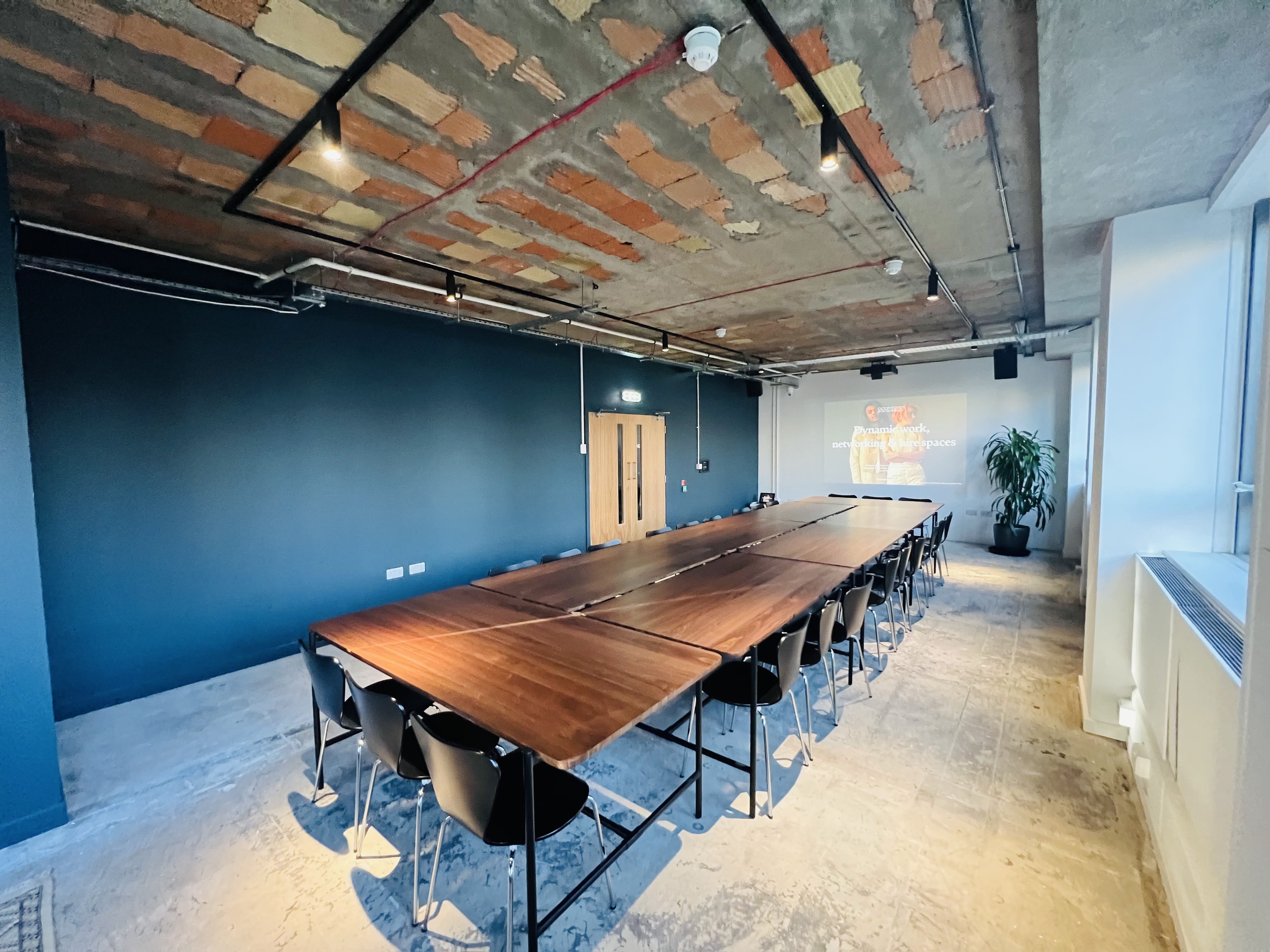 Modern meeting room with wooden table, ideal for workshops in FACTORY 15 Barking.