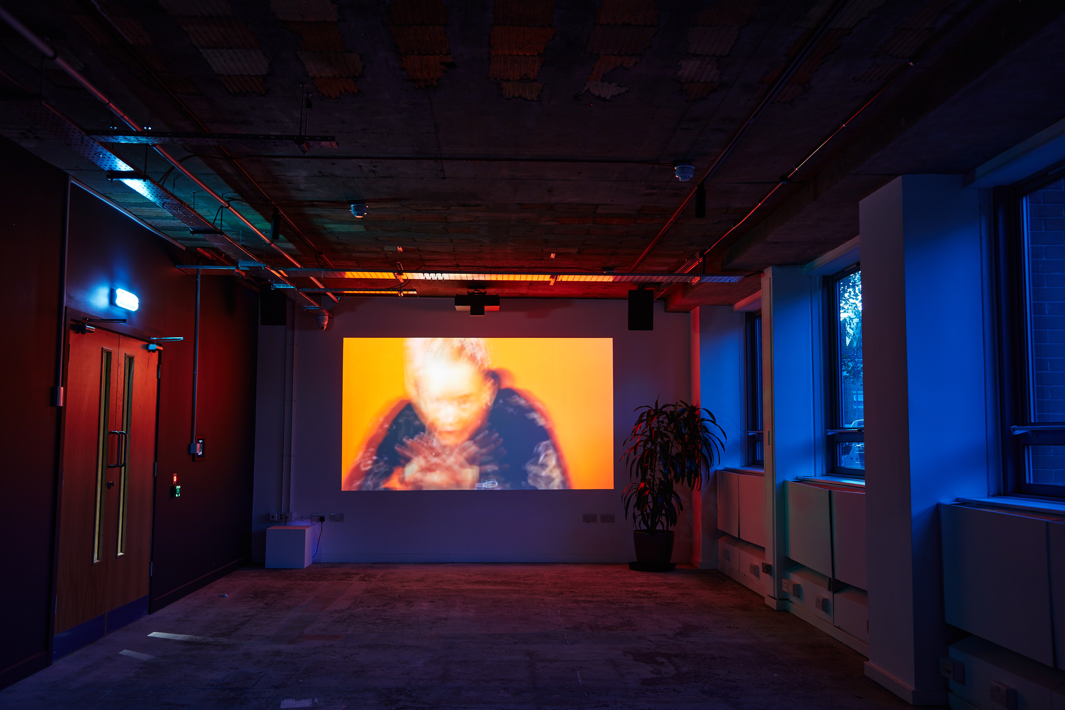 Versatile FACTORY 15 event space with large projection screen for presentations and screenings.