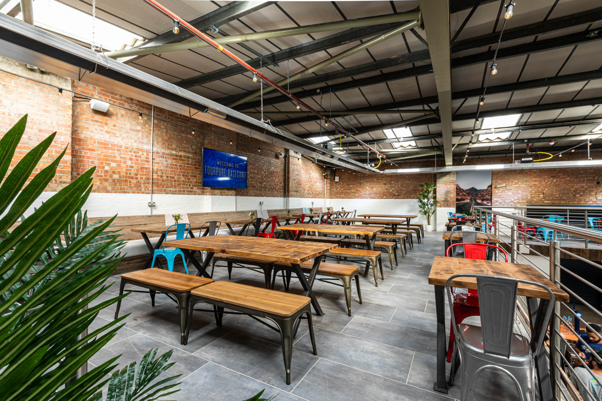 Taproom at Fourpure: industrial decor, ideal for networking events and gatherings.