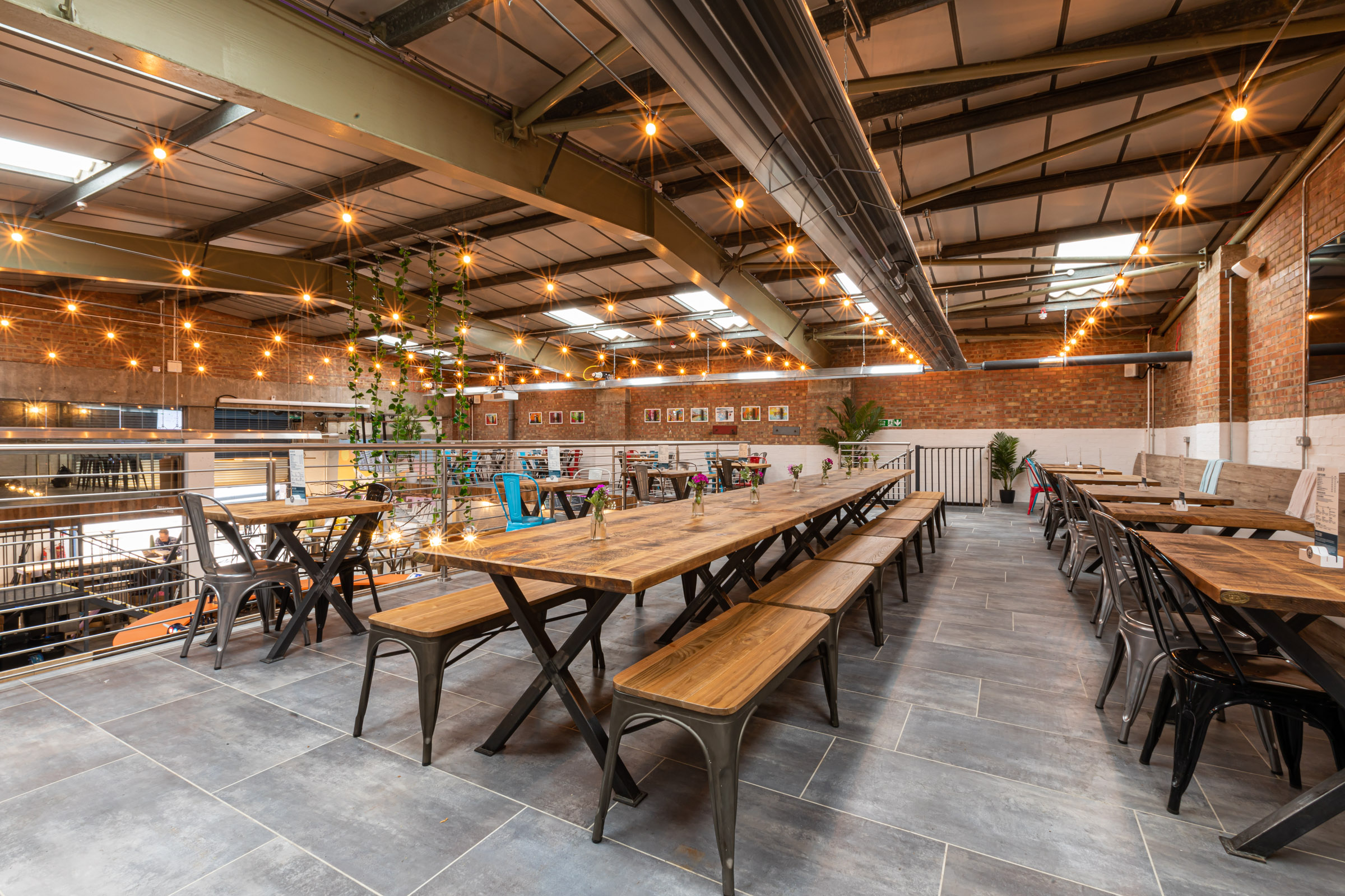 Spacious Fourpure Taproom with wooden tables, ideal for meetings and events.