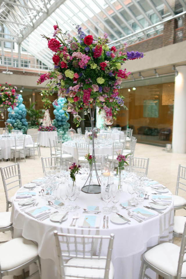 Max Rayne Atrium event space with floral centerpieces, perfect for weddings and upscale gatherings.