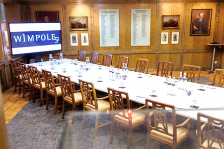 Elegant ENT meeting room with wooden paneling, ideal for professional gatherings and presentations.