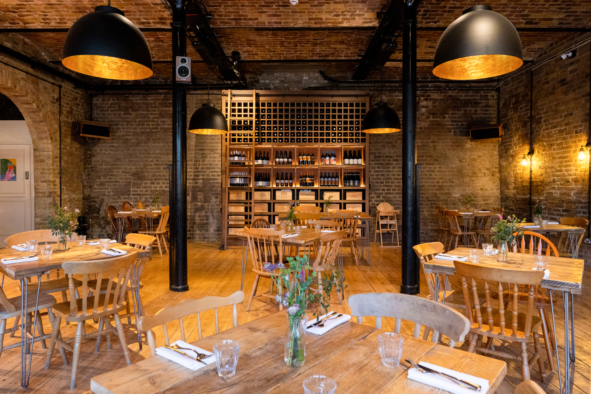 Stylish dining room with wooden tables, ideal for networking events and private dinners.